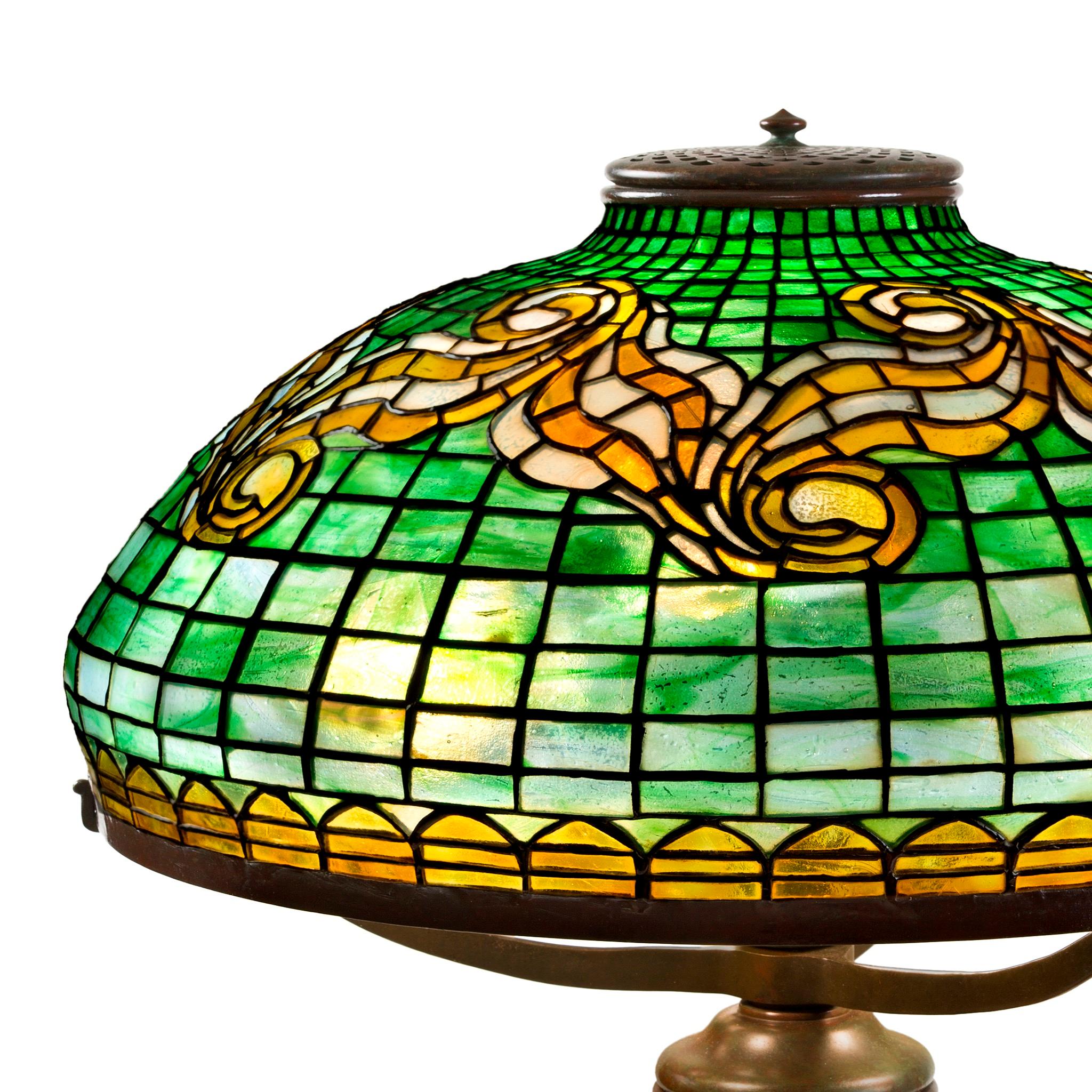 A rare and historically significant example of lyricism infused into Stark geometry, this Tiffany Studios New York glass and bronze 