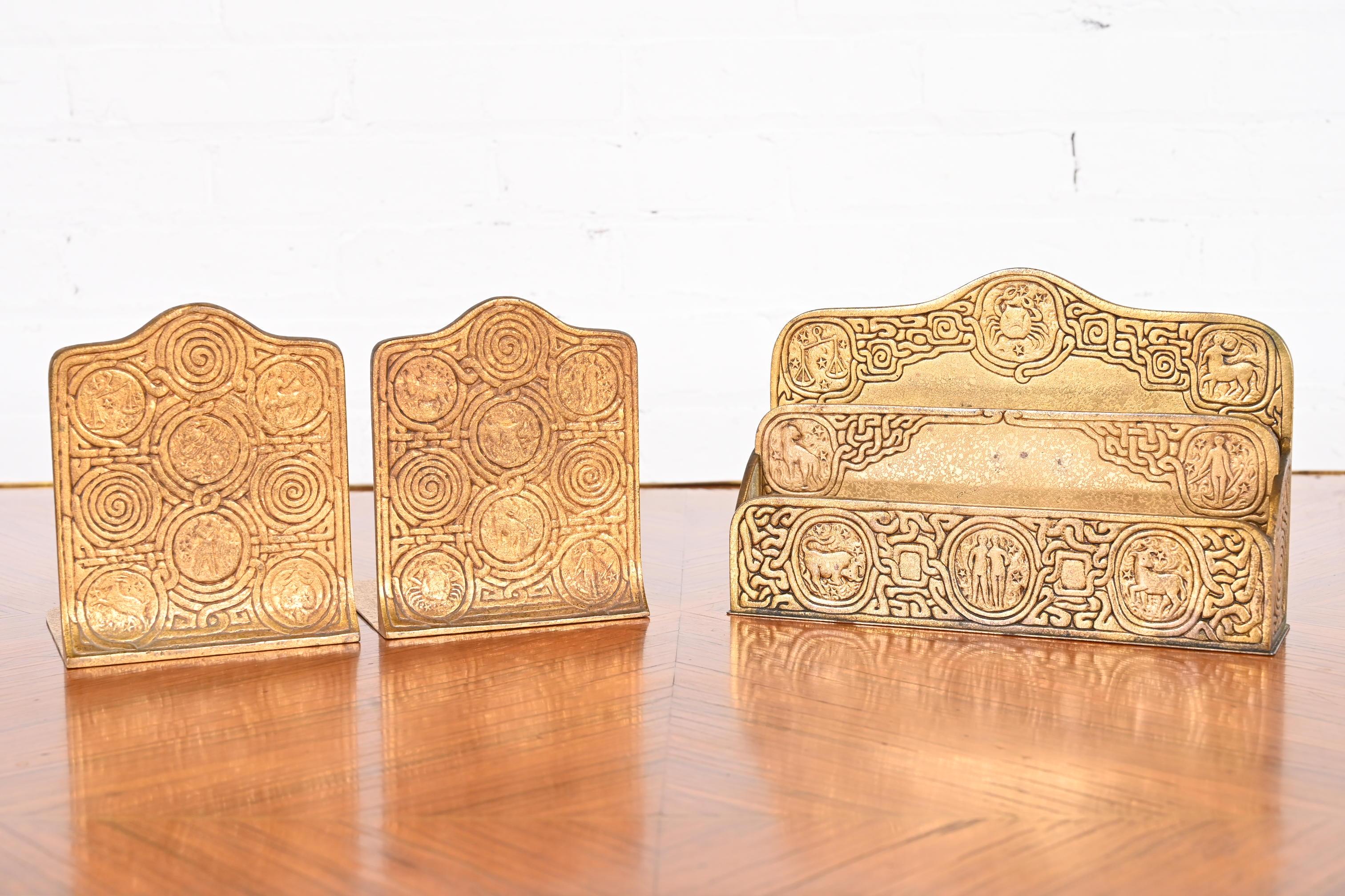 A gorgeous Art Deco period gilt bronze desk set featuring a Zodiac design. The three-piece set includes: letter rack and bookends.

By Tiffany Studios

New York, USA, early 20th century

Measures:
Letter Rack - 9.5