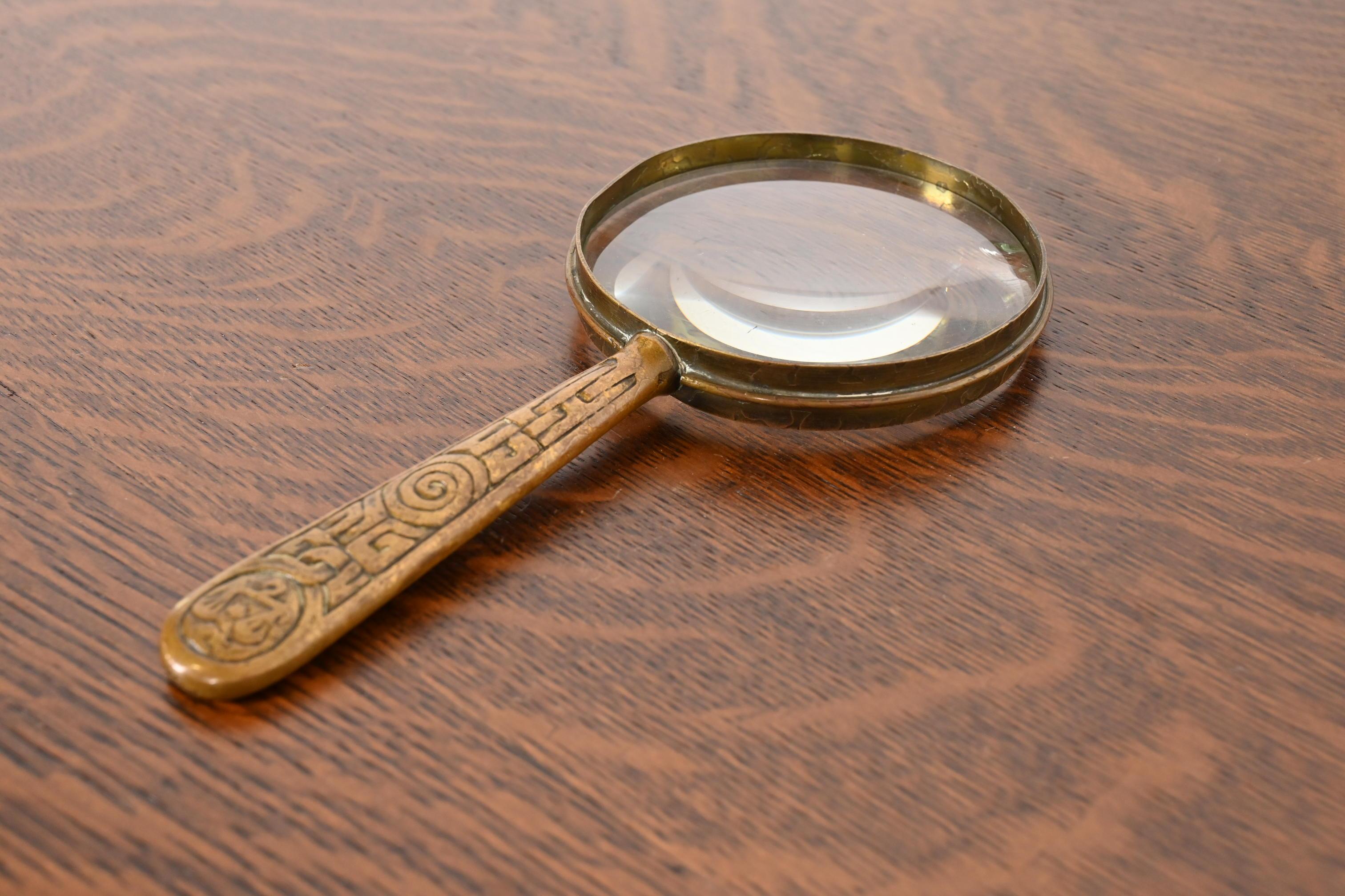 A rare and exceptional antique Arts & Crafts or Art Deco period gilt bronze Zodiac magnifying glass

By Tiffany Studios (signed on the underside)

New York, USA, Early 20th Century

Measures: 4.25