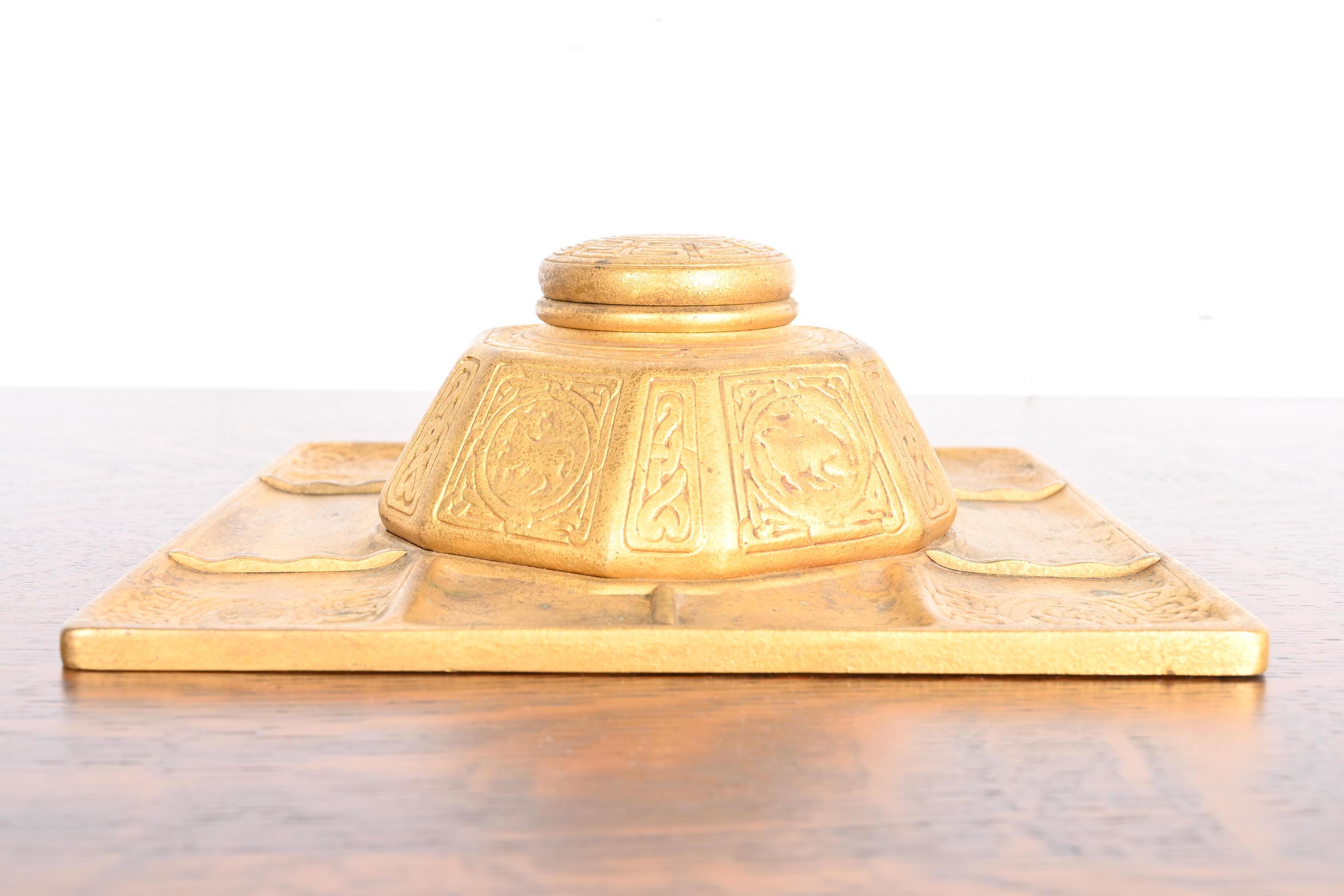 Ein wunderschönes antikes Tintenfass aus vergoldeter Bronze aus der Zeit des Arts & Crafts oder des Art Déco mit dem ikonischen Zodiac-Muster auf dem Schreibtisch.

Von Tiffany Studios (signiert auf der Unterseite)

New York, USA, Anfang des 20.