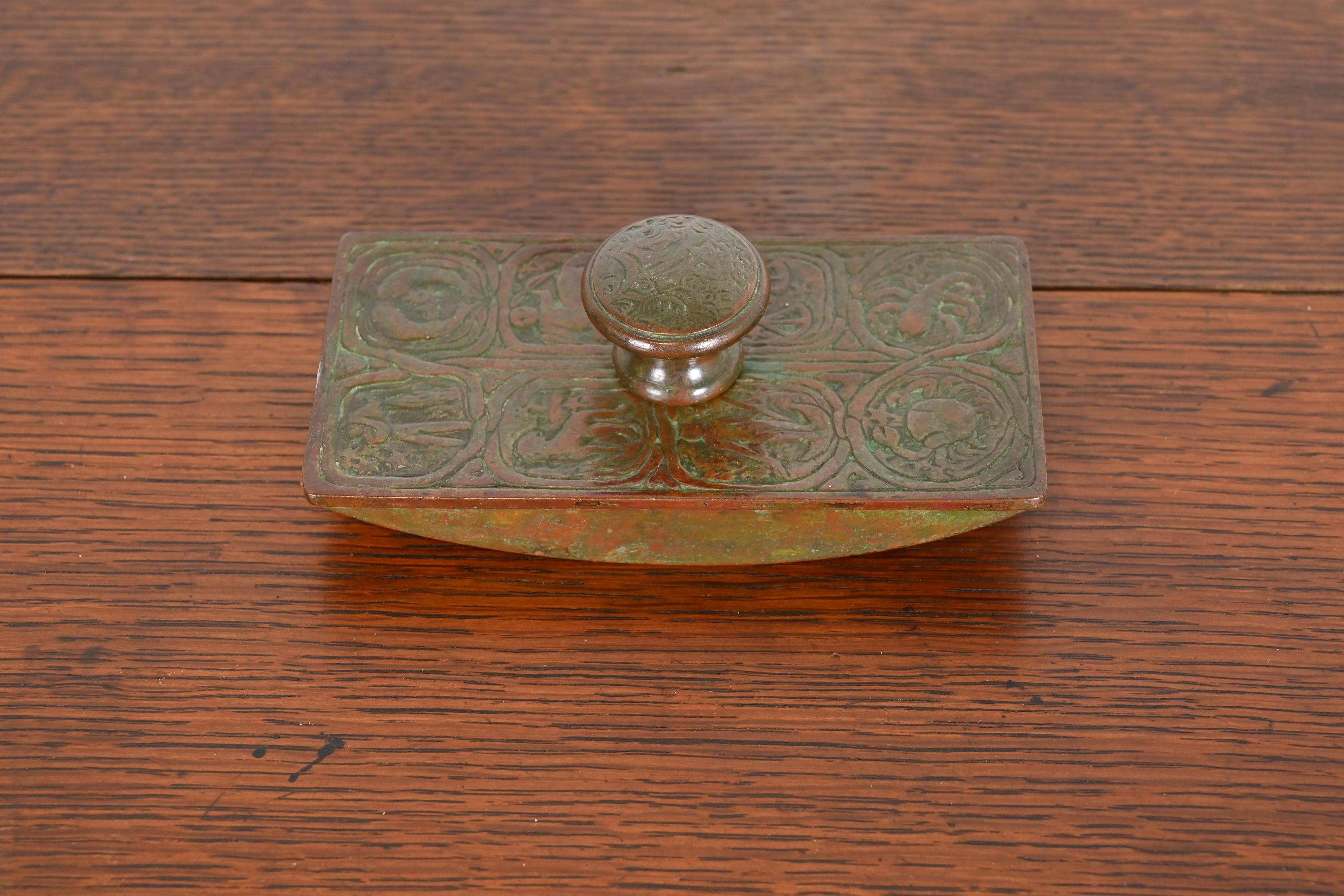 A gorgeous antique bronze rocker ink blotter featuring Zodiac designs

By Tiffany Studios

New York, USA, Early 20th Century

Measures: 5.5