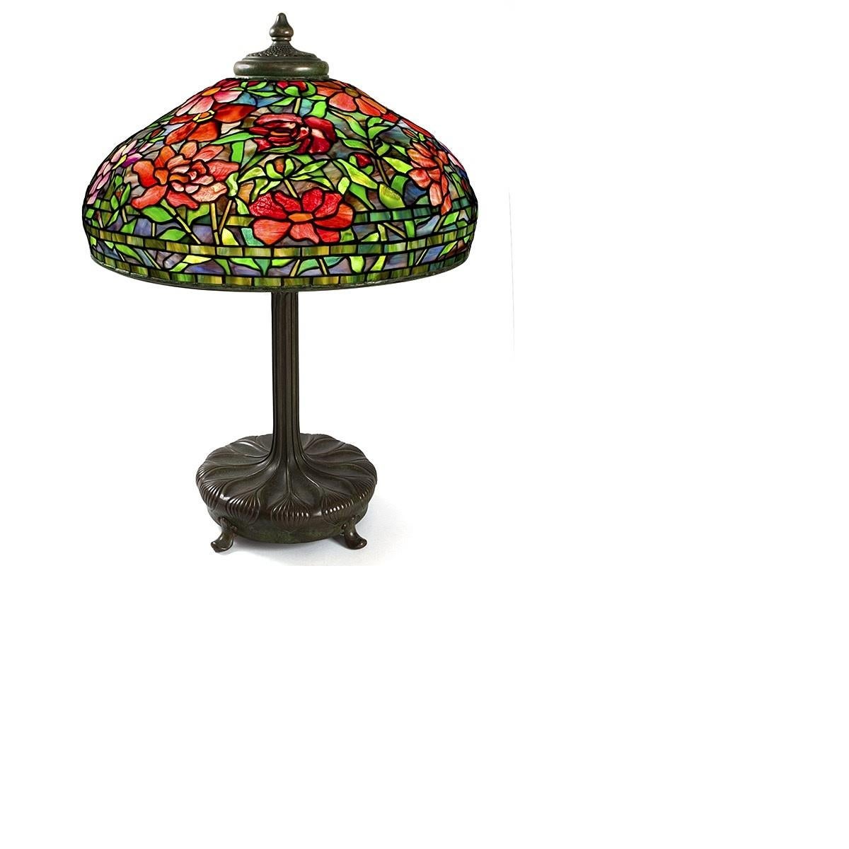 Tiffany Studios New York “Peony” leaded glass and patinated bronze table lamp. The domed shade features red, pink and purple peonies with mottled green leaves against a striated blue and lavender ground with extensive drapery glass used throughout