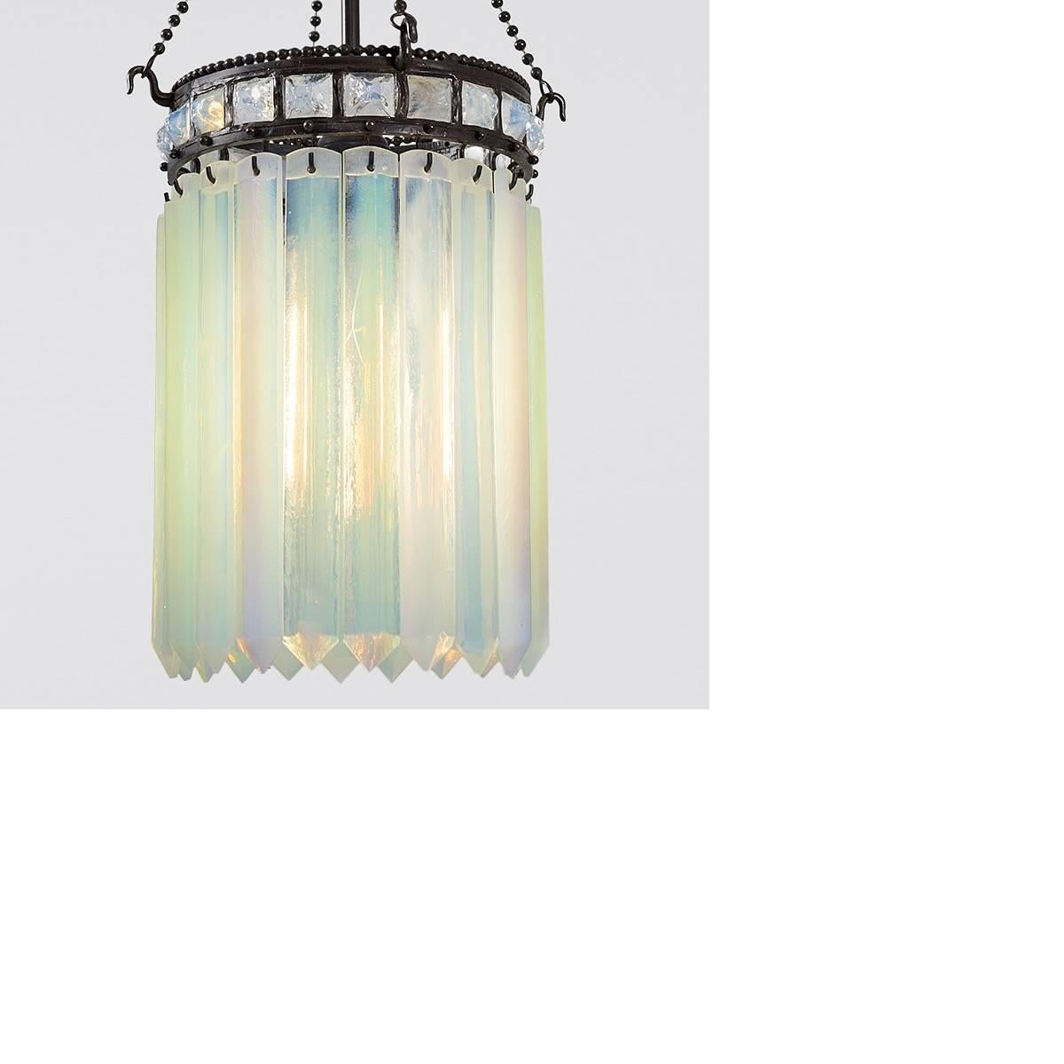 A Tiffany Studios New York “Prism” chandelier, featuring rectangular iridescent Favrile glass prisms hanging from a D\decorated bronze crown featuring a total of 20 opalescent hanging prisms and 20 irregular opalescent pyramids vertically set, circa