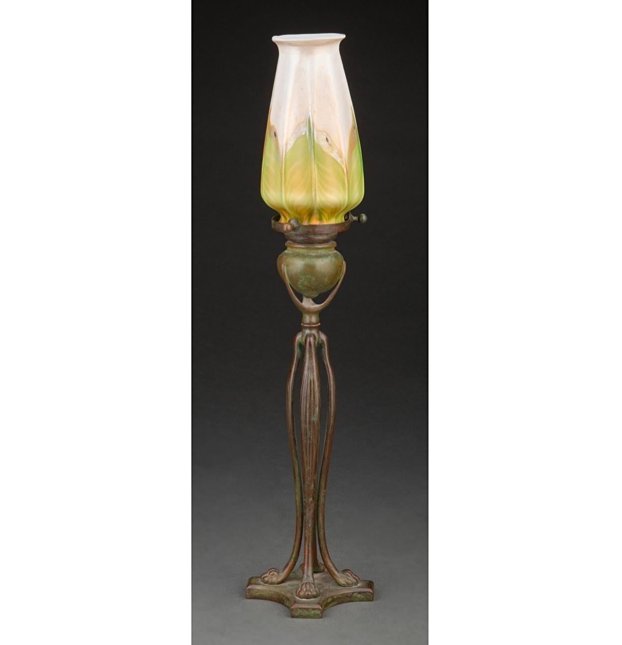 Tiffany Studios Pulled feather favrile glass and bronze candlestick lamp, circa 1910 A lovely Art Nouveau candelabra with a early decorated L.C.T Tiffany glass shade. This ensemble will adorn your living room, study, library or bedroom