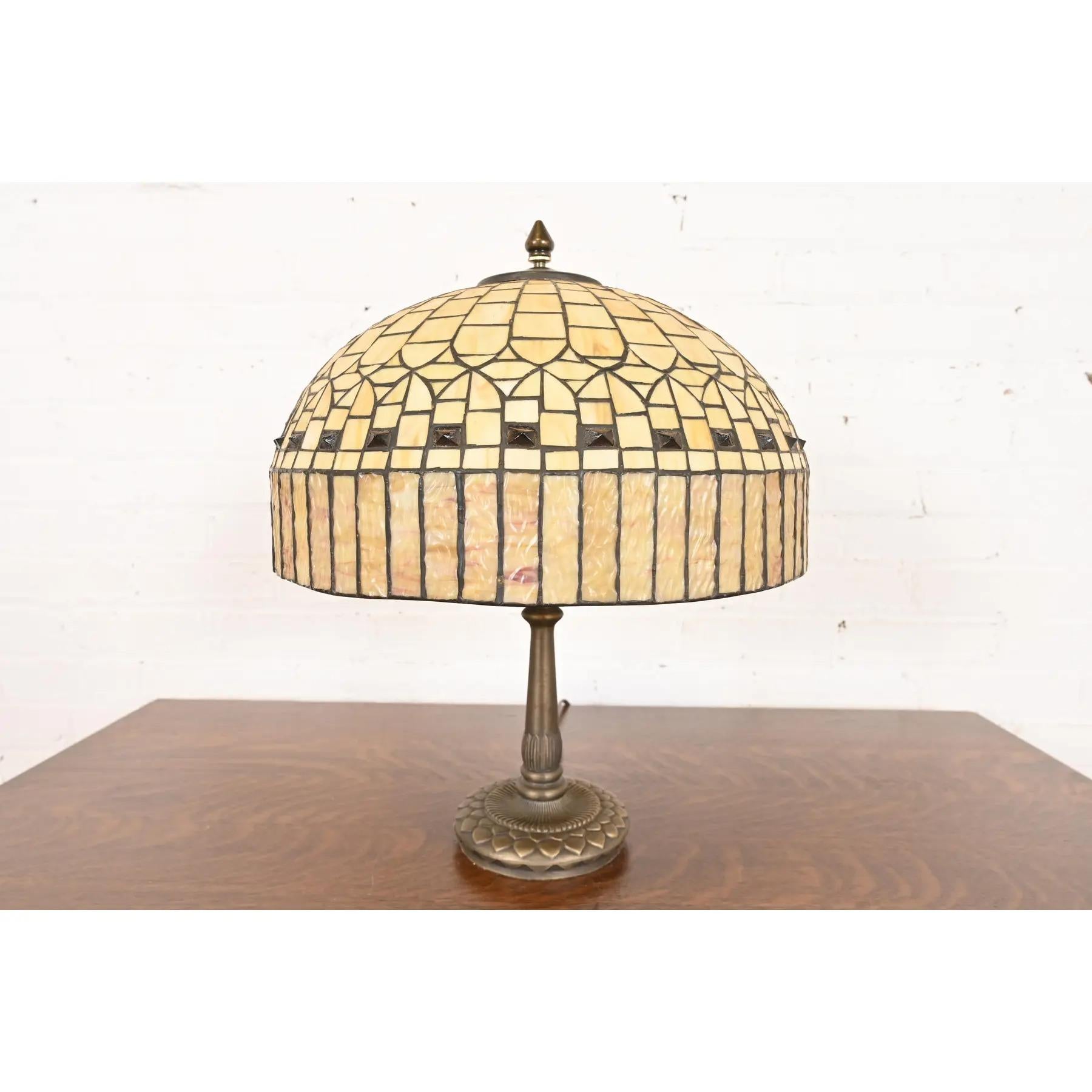 A gorgeous Arts & Crafts table lamp with jeweled stained caramel glass shade

In the manner of Tiffany Studios 

USA, Late 20th Century

Measures: 15.5