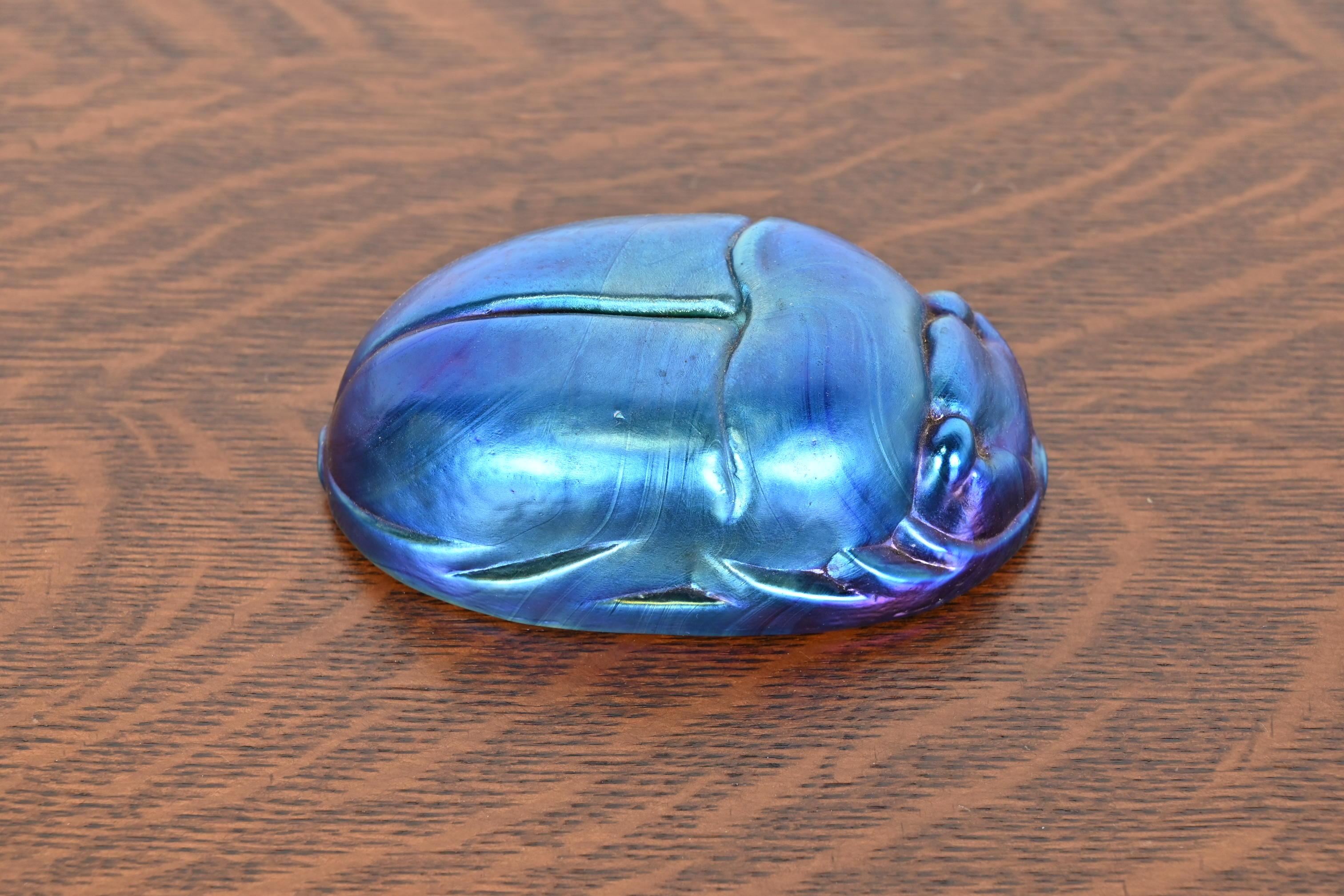 A gorgeous Arts & Crafts or Art Deco style iridescent favrile glass scarab paper weight

In the manner of Tiffany Studios

USA, 20th Century

Measures: 5