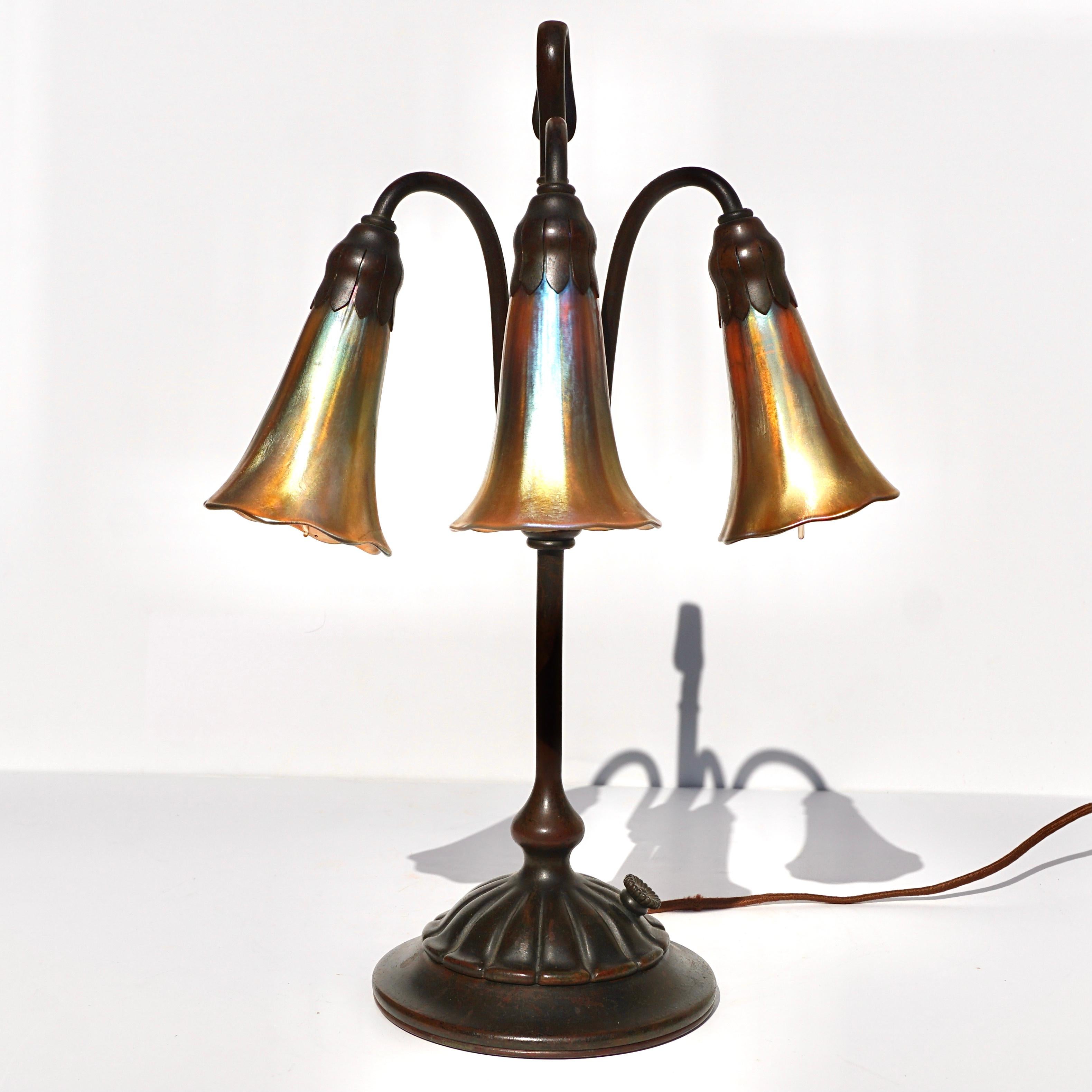 Tiffany Studios New York bronze and favrile lily shade table lamp.
Table lamp model 