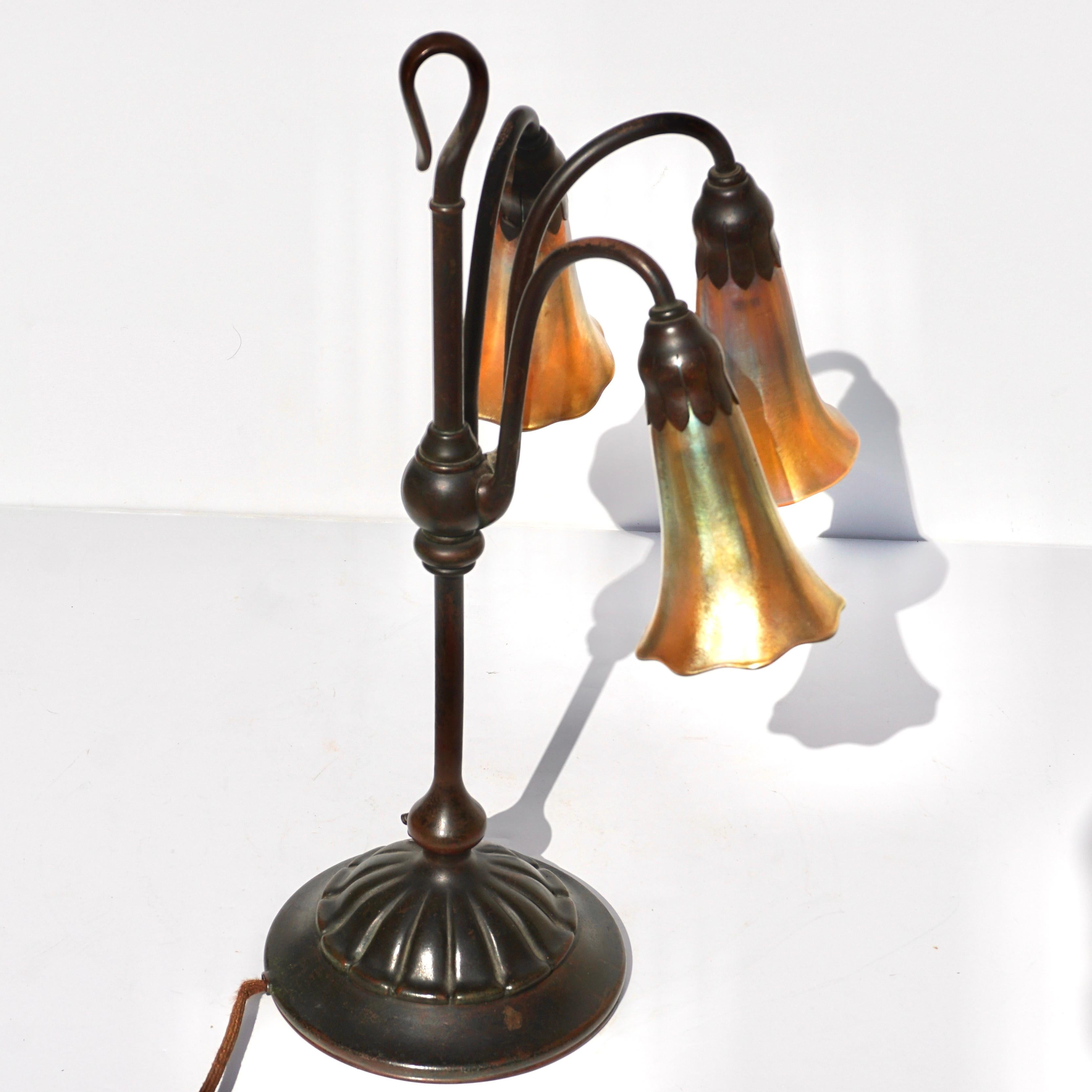 Early 20th Century Tiffany Studios Three Light Lily Bronze and Favrile Table Lamp