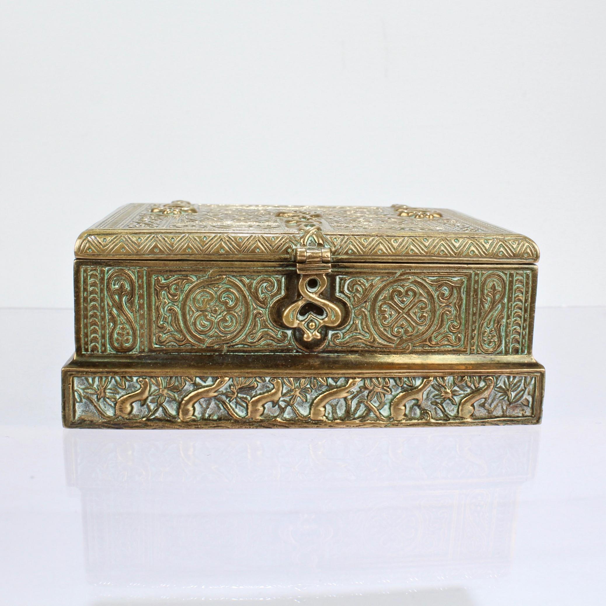 A wonderful gilt bronze Tiffany Studios hinged box from a desk set.

In the Venetian pattern, with a stepped base, and decorated with stylized flowers, leaves, scrolls, and faux strap hinges.

Model No. 1680

A great piece of Tiffany bronze in