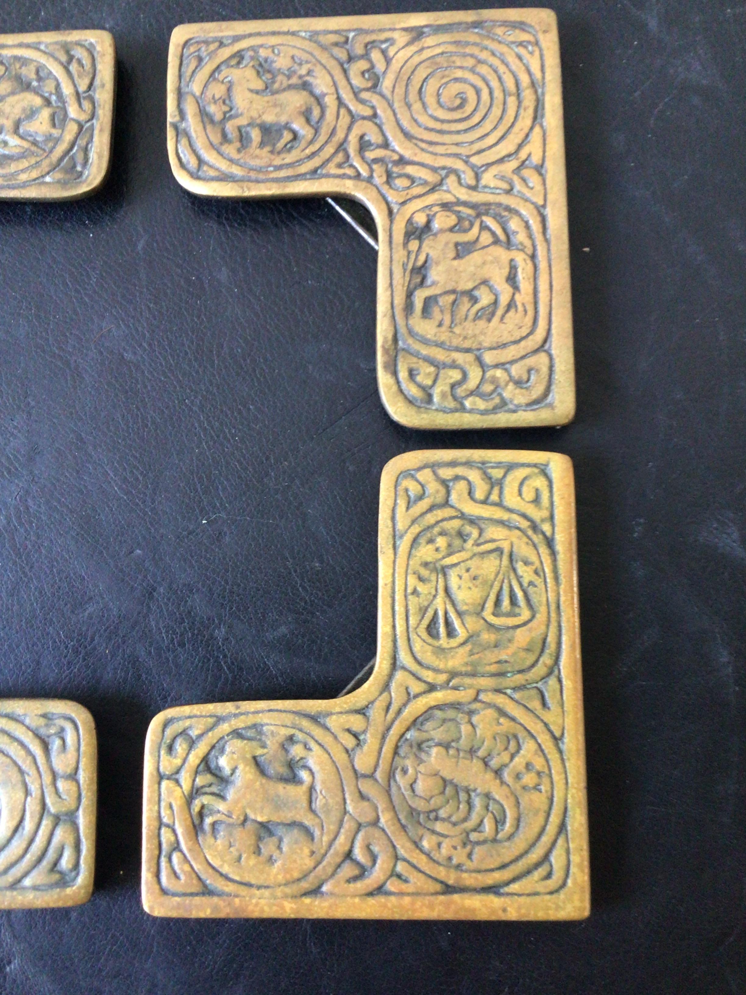 1920s Tiffany Studios bronze Zodiac blotter corners.