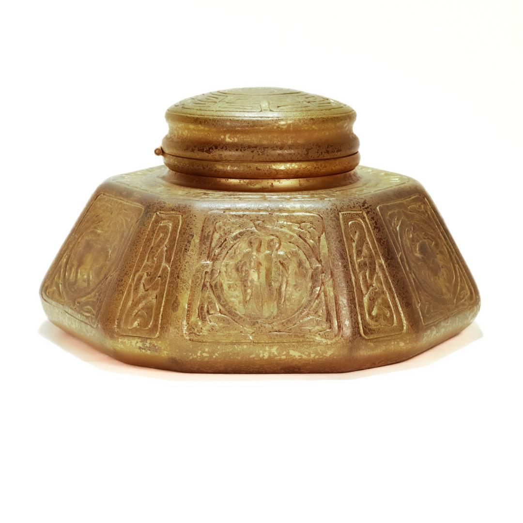 A fine Tiffany Studios gilt bronze inkwell.

In the Zodiac pattern.

Model no. 1072.

Simply iconic Tiffany design!

Date:
Early 20th Century

Overall Condition:
It is in overall good, as-pictured, used estate condition.

Condition Details:
There is