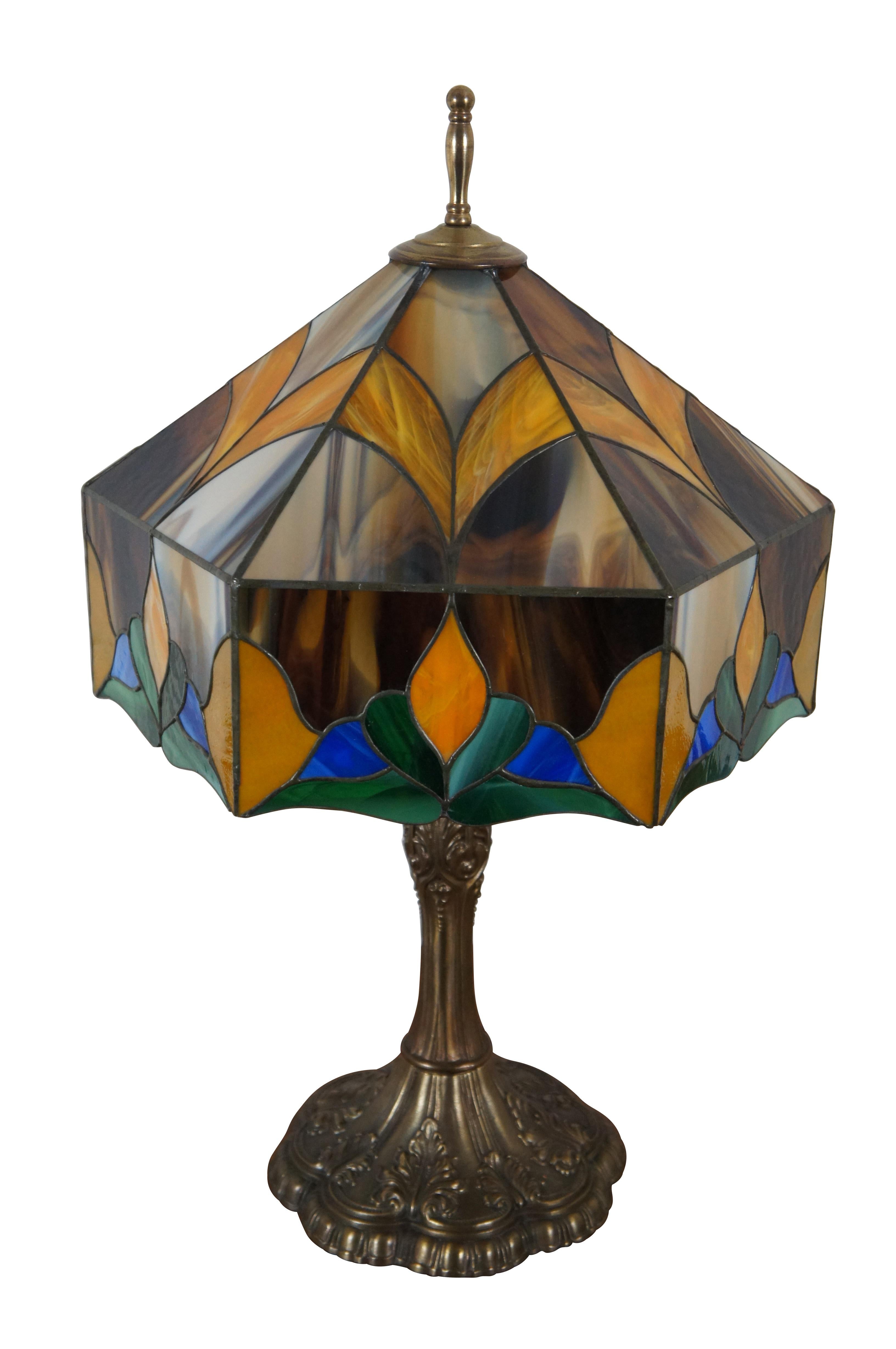 Vintage Tiffany style stained slag glass two light parlor table lamp featuring Art Nouveau styling with beautiful abstract floral design shade of blues, greens, orange and tortoise brown supported by a tapered and scalloped acanthus