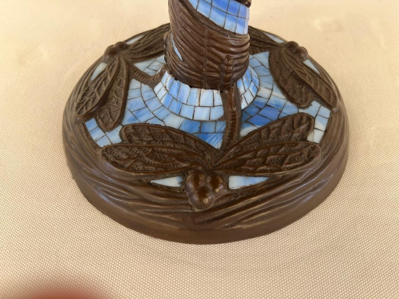 Tiffany style table lamp one of the first large-scale reproductions, on the base are relief butterflies surrounded by mosaic glass , the stem is covered with glass while the cap is an explosion of colored glass. Contained inside are 3 bulb holders.