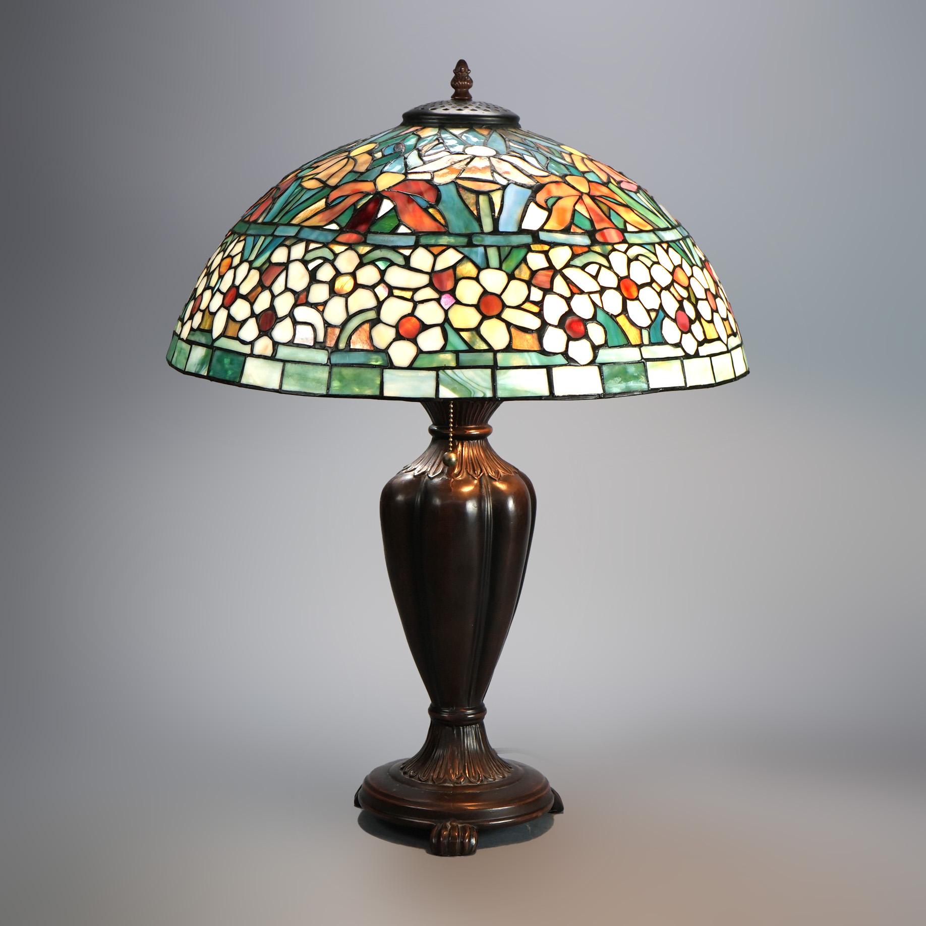 Tiffany Style Leaded Stained Glass Lamp with Shade having Floral Pattern over Double Socket Urn Form Base 20thC

Measures- 26.5''H x 20''W x 20''D