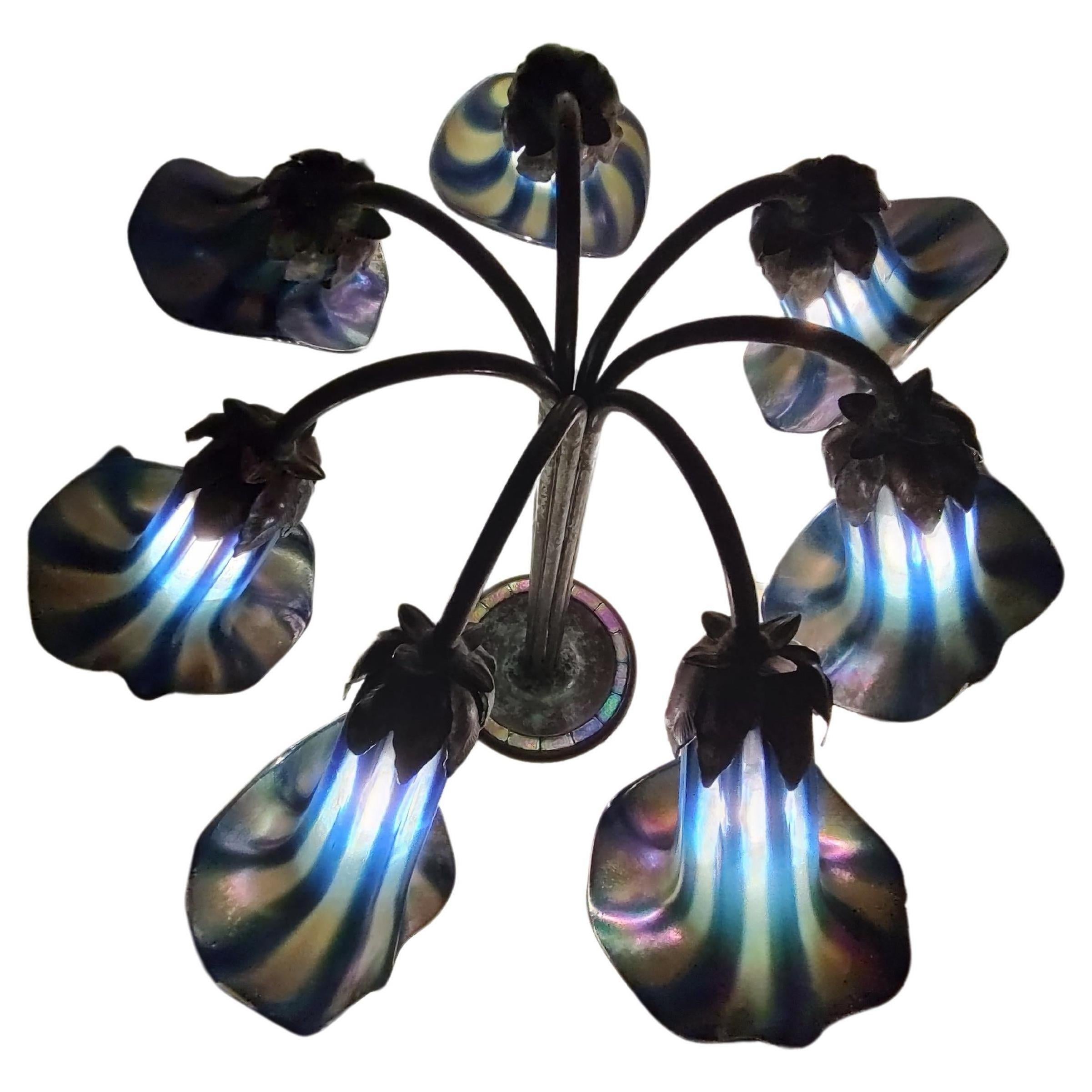 Fabulous colorful glass shades and in the base also. Hand crafted in bronze this seven light Lily lamp will undoubtedly enhance your room. Stamped Tiffany Studios New York. In excellent vintage condition with minimal wear.