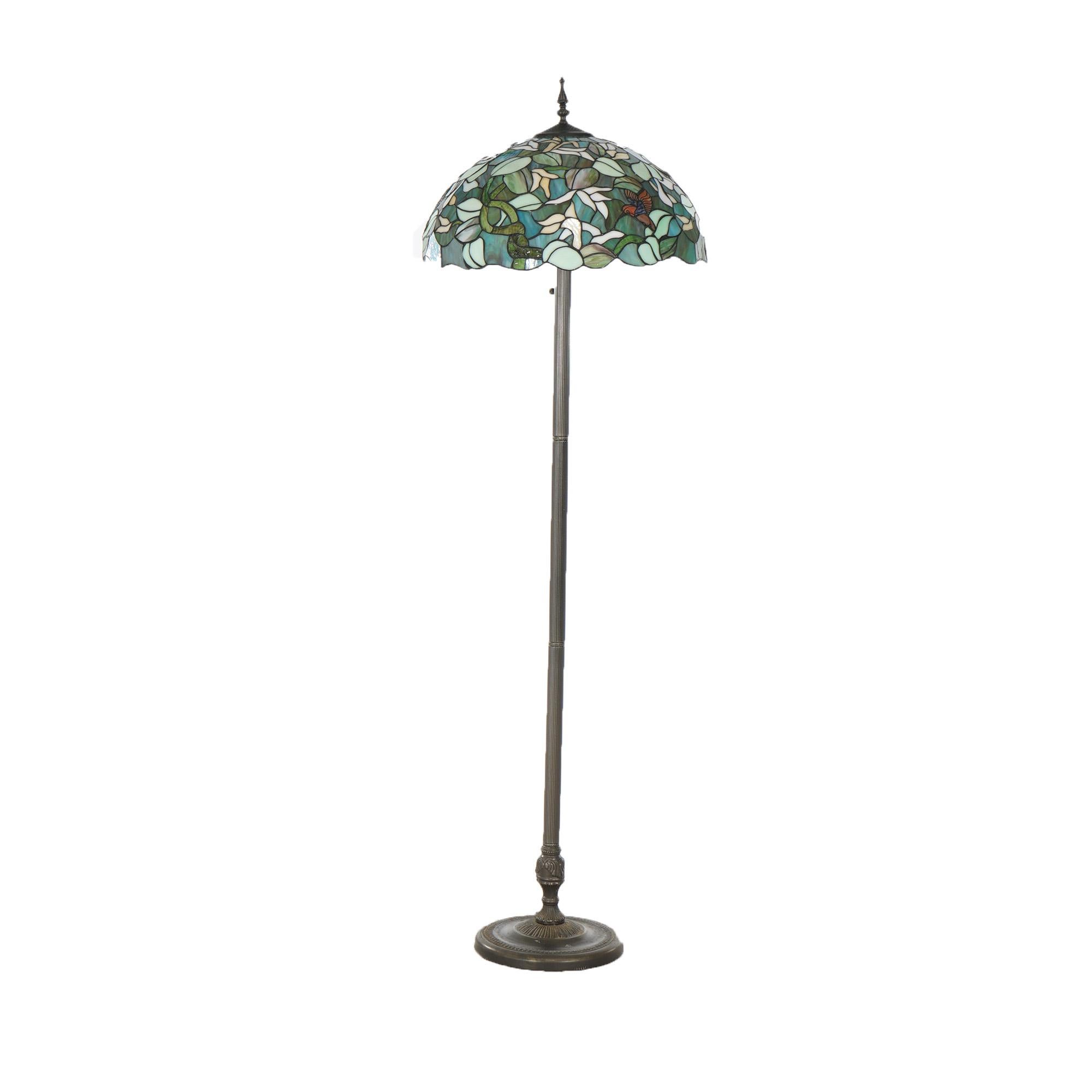 Leaded Stained Glass Floor Lamp in the Manner of Tiffany with Flower & Hummingbird Design over Triple Socket Base, 20thC

Measures- 64''H x 20''W x 20''D