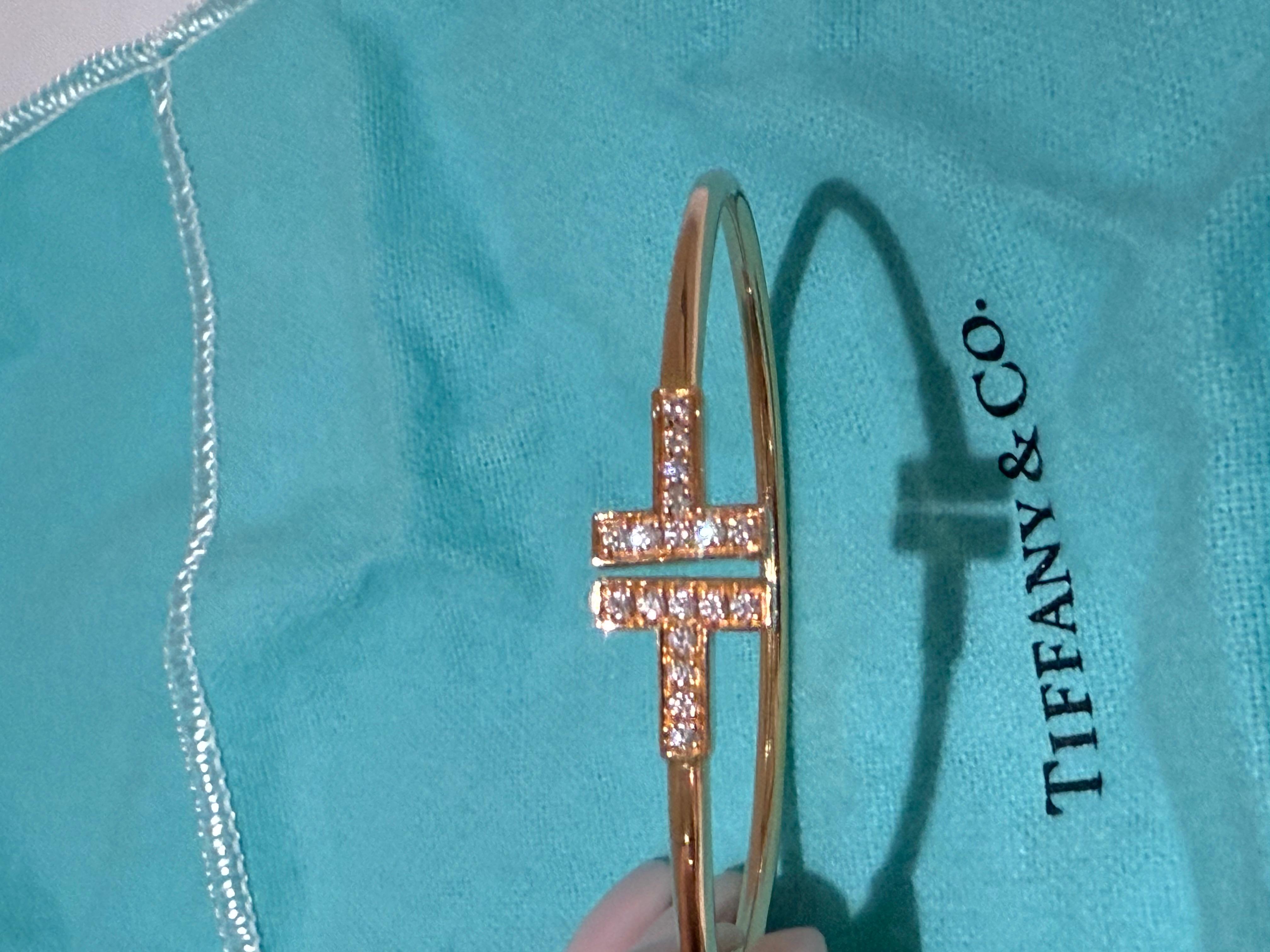 Tiffany T Diamond Wire Bracelet in 18K Rose Gold  by Tiffany & Co. The bracelet comprises of two iconic Tiffany T motifs in a cuff style, pave set with 18 round brilliant cut diamonds with an approximate weight of 0.24ct, F-G colour and VS clarity.