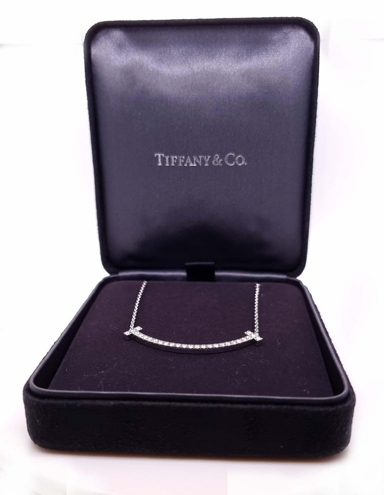 Unique features:
Graphic angles and clean lines blend to create the beautiful clarity of the Tiffany T collection. Traced with scintillating diamonds, the sleek curve of this pendant makes an elegant style statement.

18k white gold with round