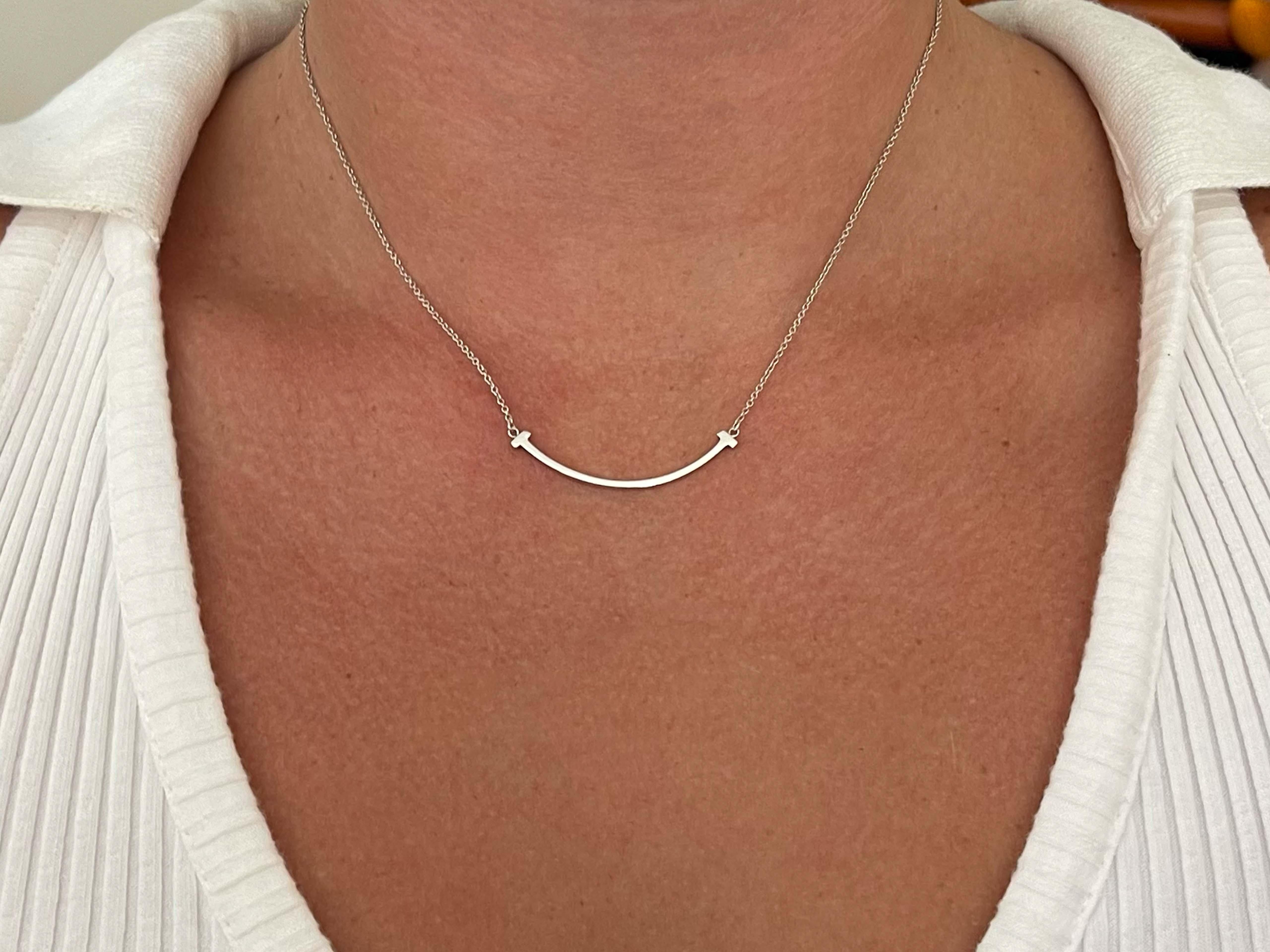 Tiffany T Small Smile Pendant Necklace in Sterling Silver. This is an authentic TIFFANY Sterling Silver Small T Smile Pendant Necklace. The necklace is crafted of sterling silver and features a T smile motif pendant on a silver chain. The pendant