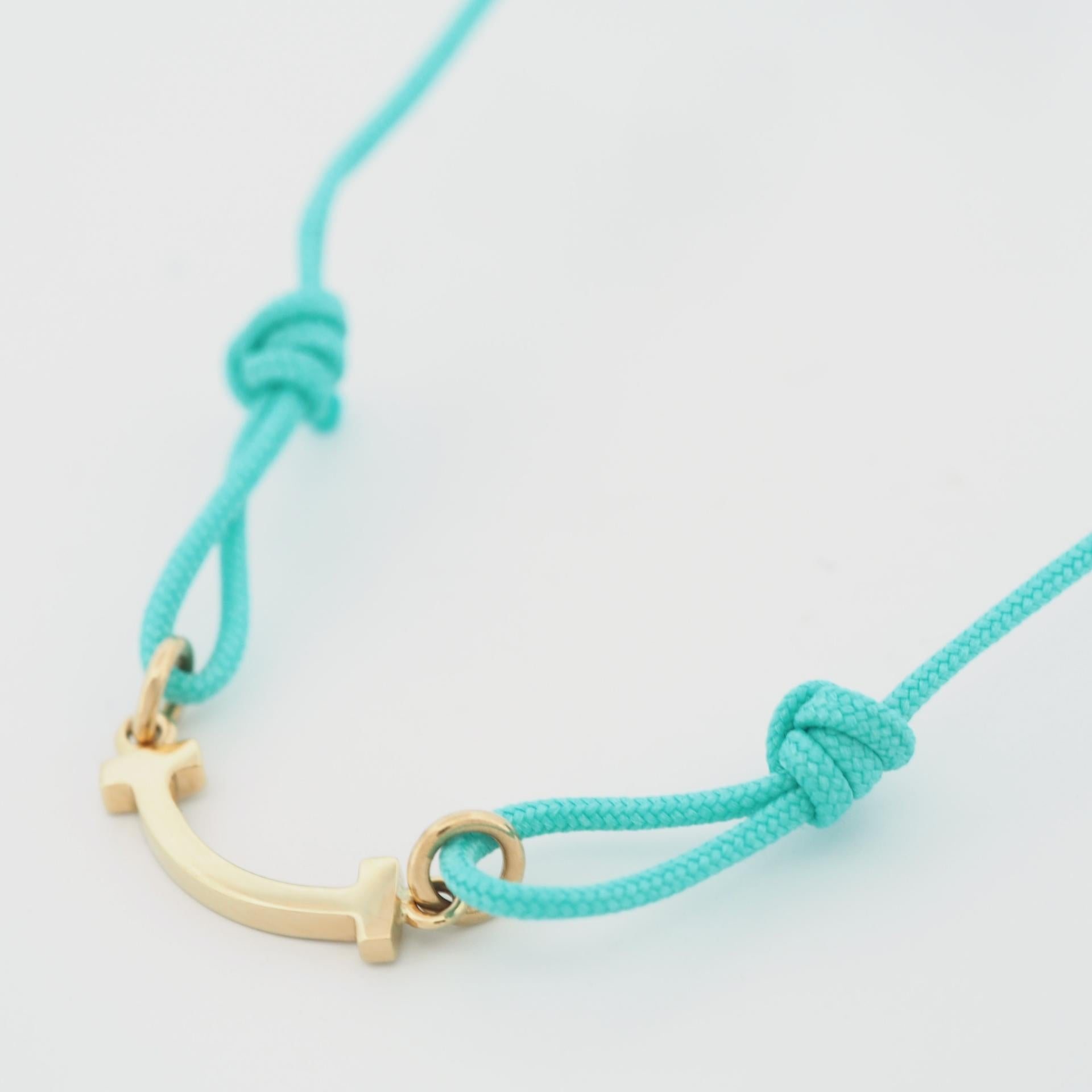Women's or Men's Tiffany T Smile Bracelet in Yellow Gold on a Blue Cord