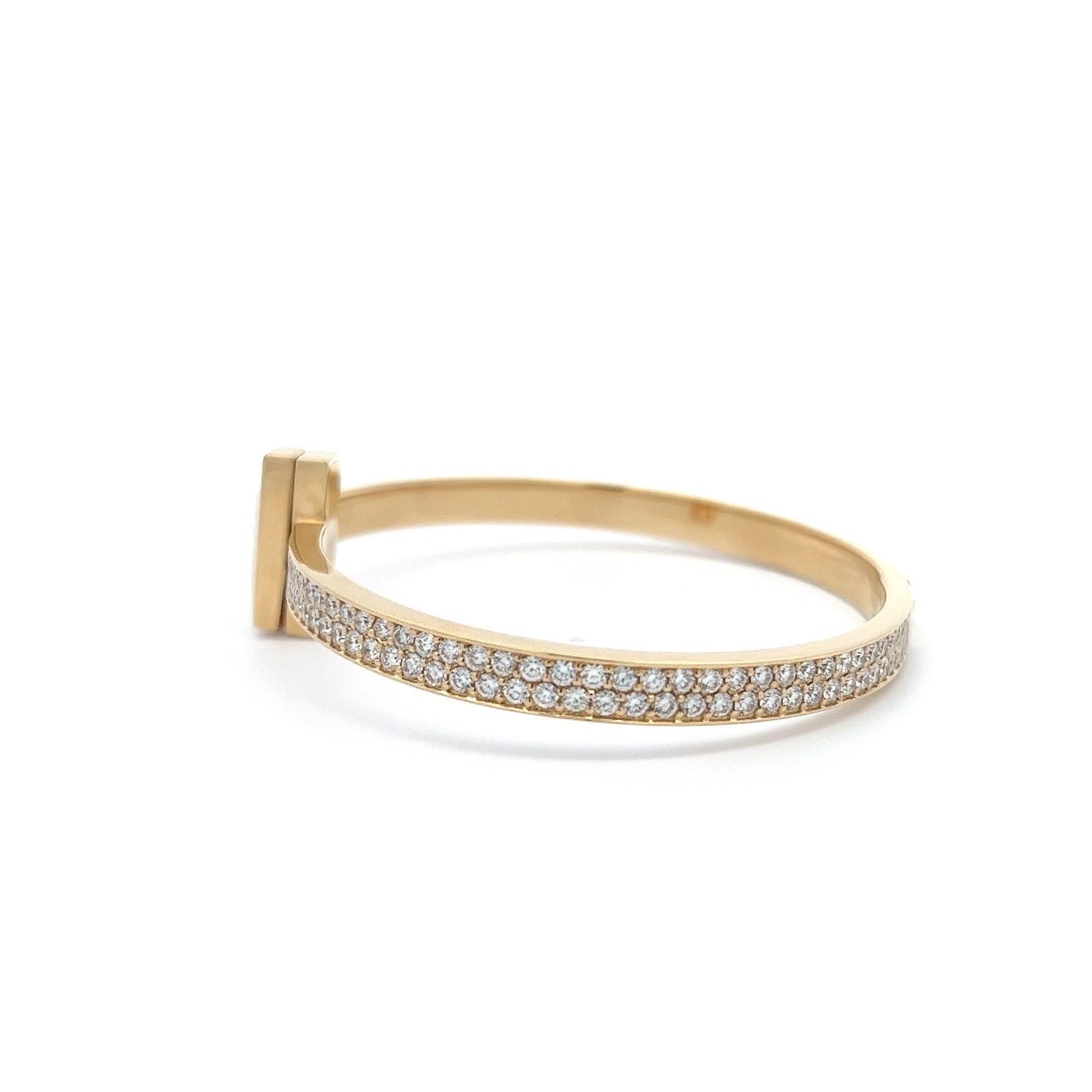 Introducing the Tiffany & Co. T1 Diamond Hinged Bracelet Cuff, a true embodiment of elegance and sophistication. Crafted with meticulous attention to detail, this exquisite bracelet exudes timeless beauty and luxury.

The bracelet features a sleek