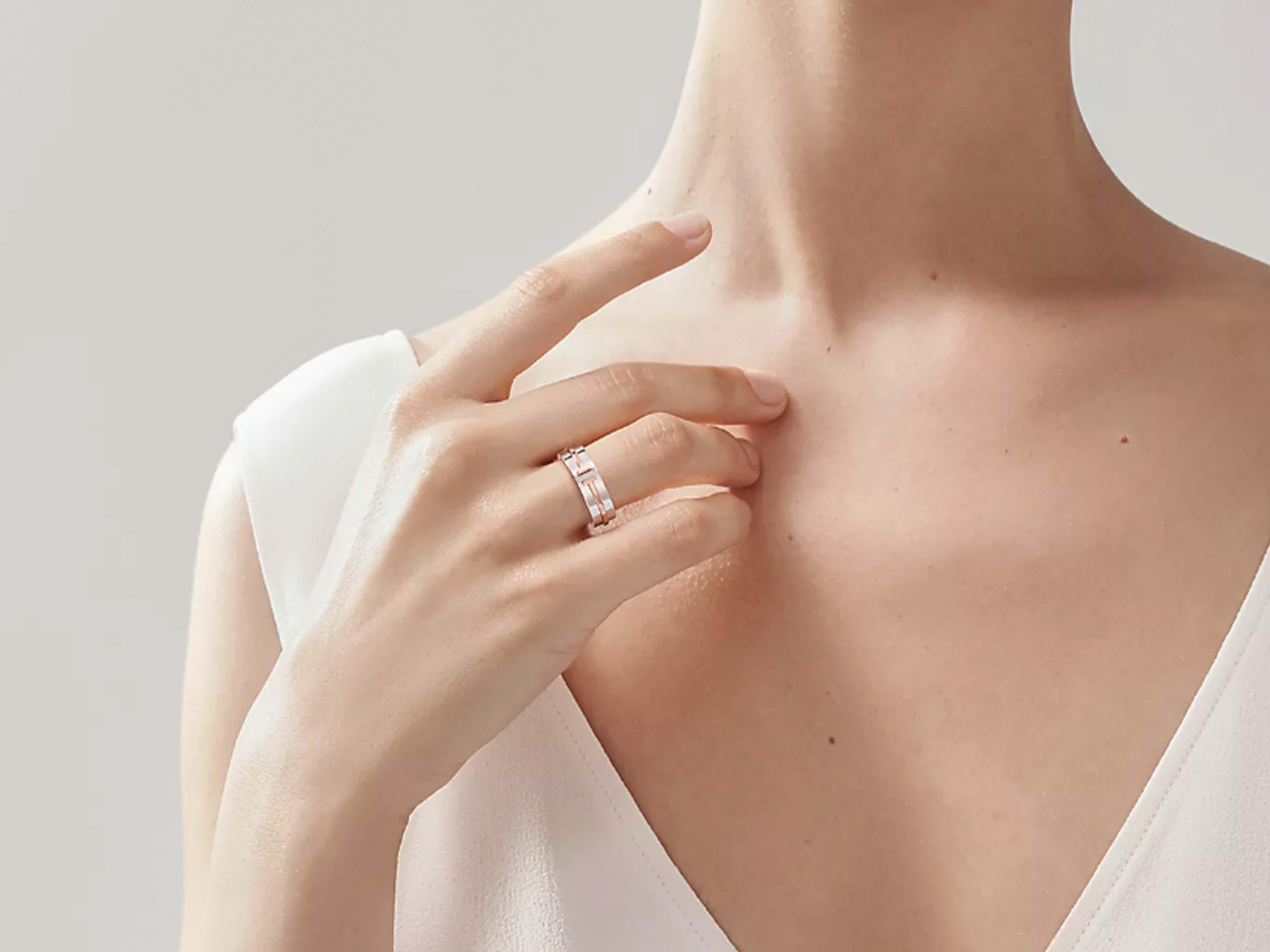 Authentic Tiffany T Wide Band Ring in Sterling Silver and 18k Rose Gold. The bold lines of this timeless design highlight the powerful form of the letter 