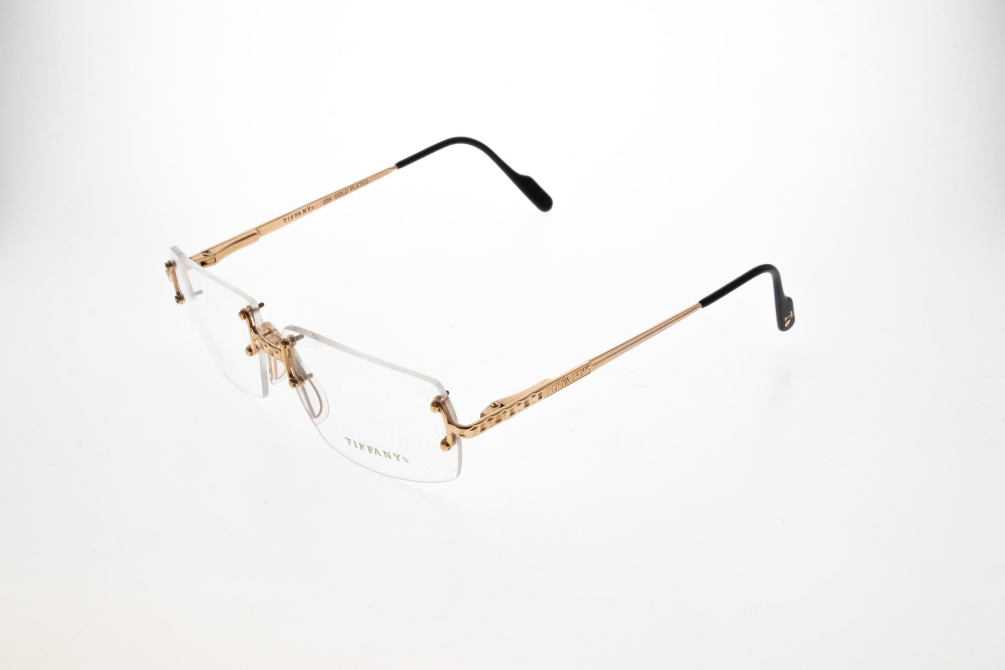 Original 1990’s Tiffany & Co T100 gold plated rimless frames. Tiffany & Co was founded in 1837 by Charles Lewis Tiffany, with it’s flagship store located on Fifth Avenue New York. Tiffany set the standard for sterling silver jewellery, demonstrating