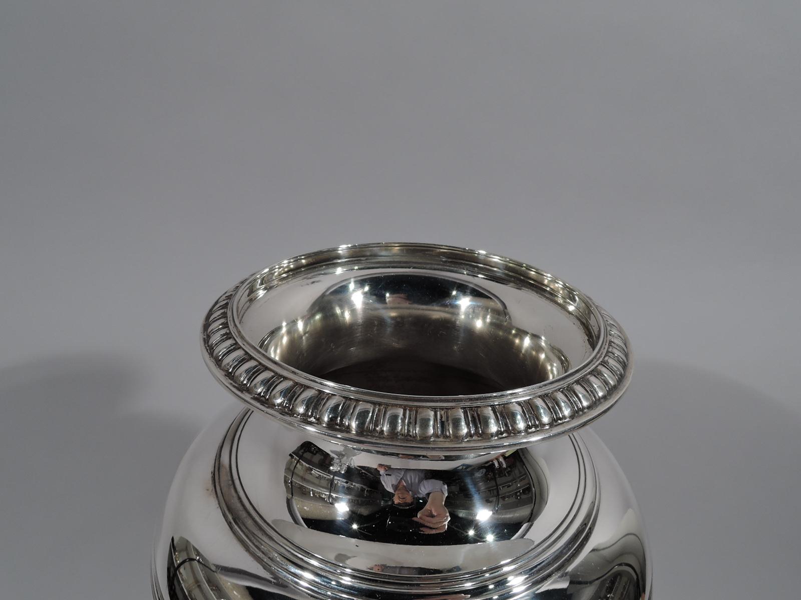 Tall Art Deco classical sterling silver vase. Made by Tiffany & Co. in New York, circa 1920. Baluster with curved shoulder and round foot. Body and neck plain with contrasting stylized ornament: Classical leaf-and-dart on foot and bead-and-reel on