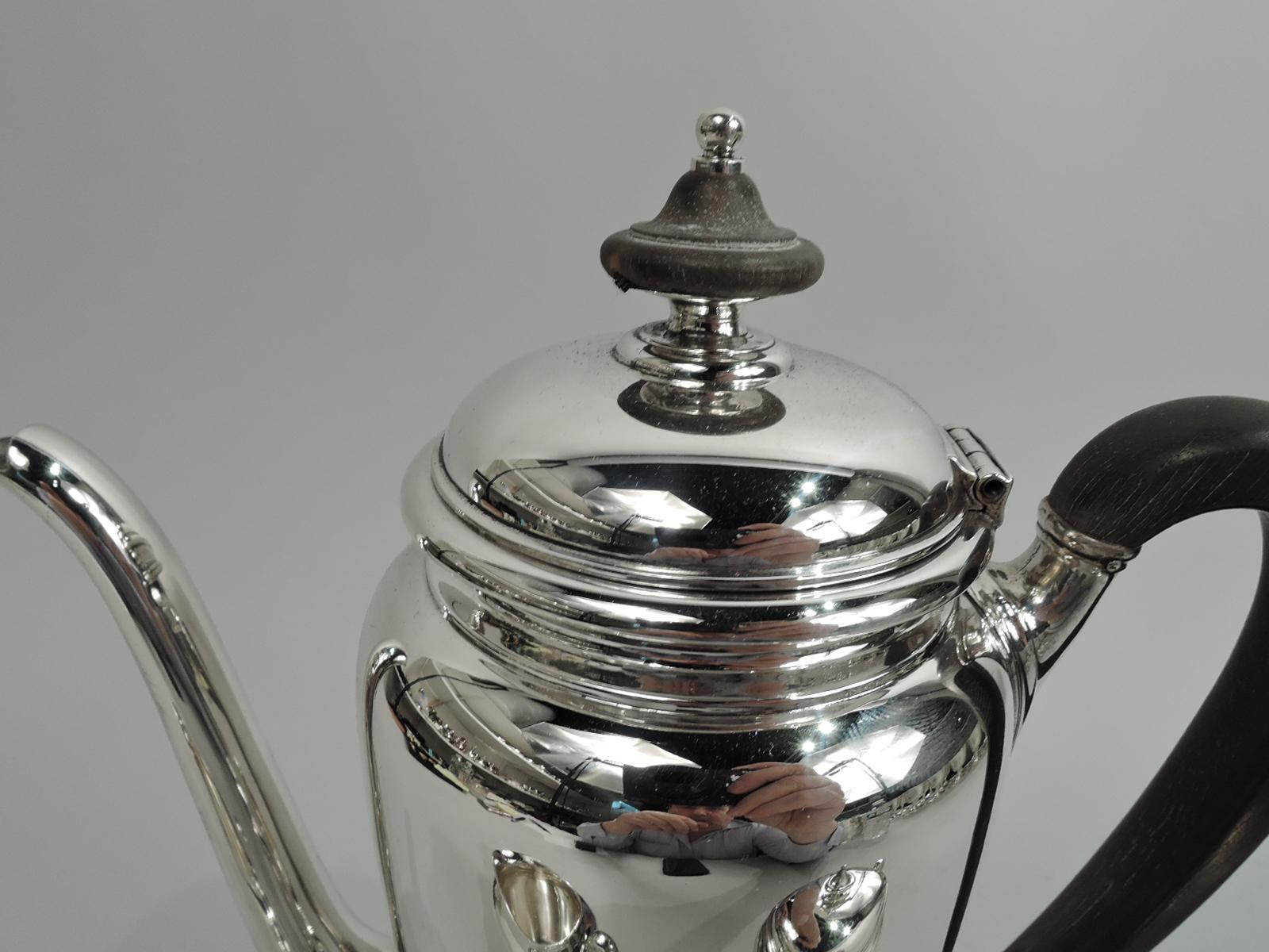 Traditional sterling silver coffee set. Made by Tiffany & Co. in New York, ca 1925. This set comprises coffeepot, creamer, and sugar. Curved and tapering bodies on round and stepped foot. Covers raised with vasiform finial and handles high-looping.