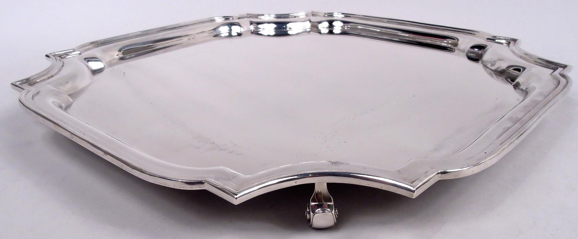 Traditional Georgian sterling silver salver. Made by Tiffany & Co. in New York. Square cartouche with molded curvilinear rim and corner capped volute-scroll supports. Fully marked including maker’s stamp and postwar pattern no. 25147. Weight: 49