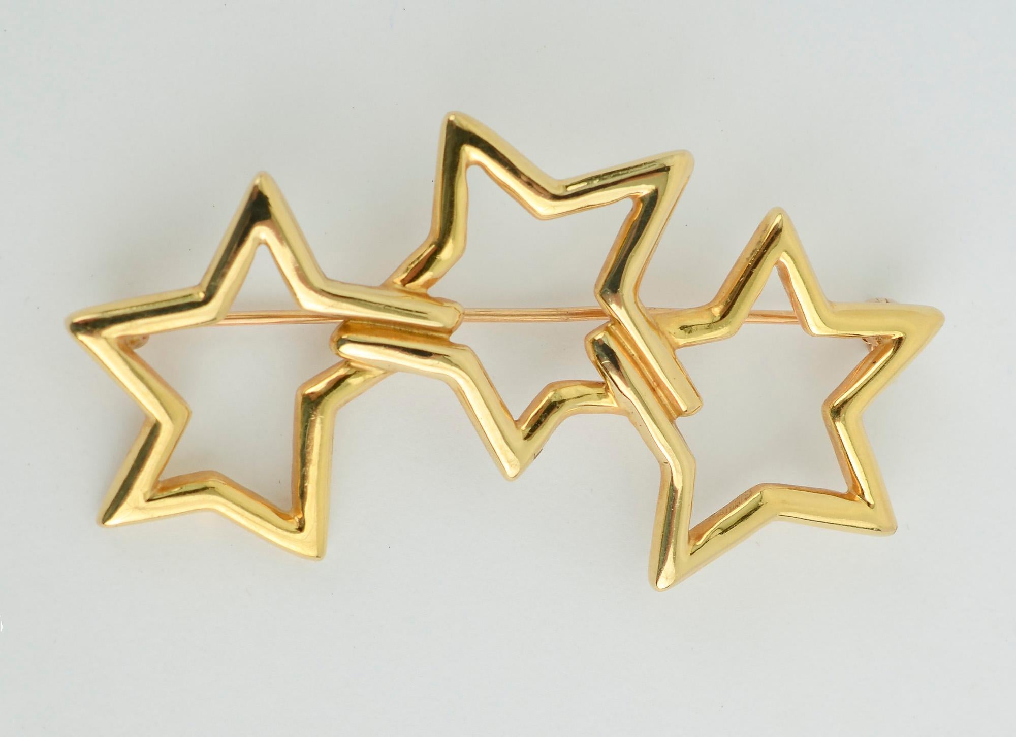 Irregular five point stars are combined to overlap in this airy brooch by Tiffany. It can be worn vertically or horizontally on a lapel.
It measures 2.07 inches in width.