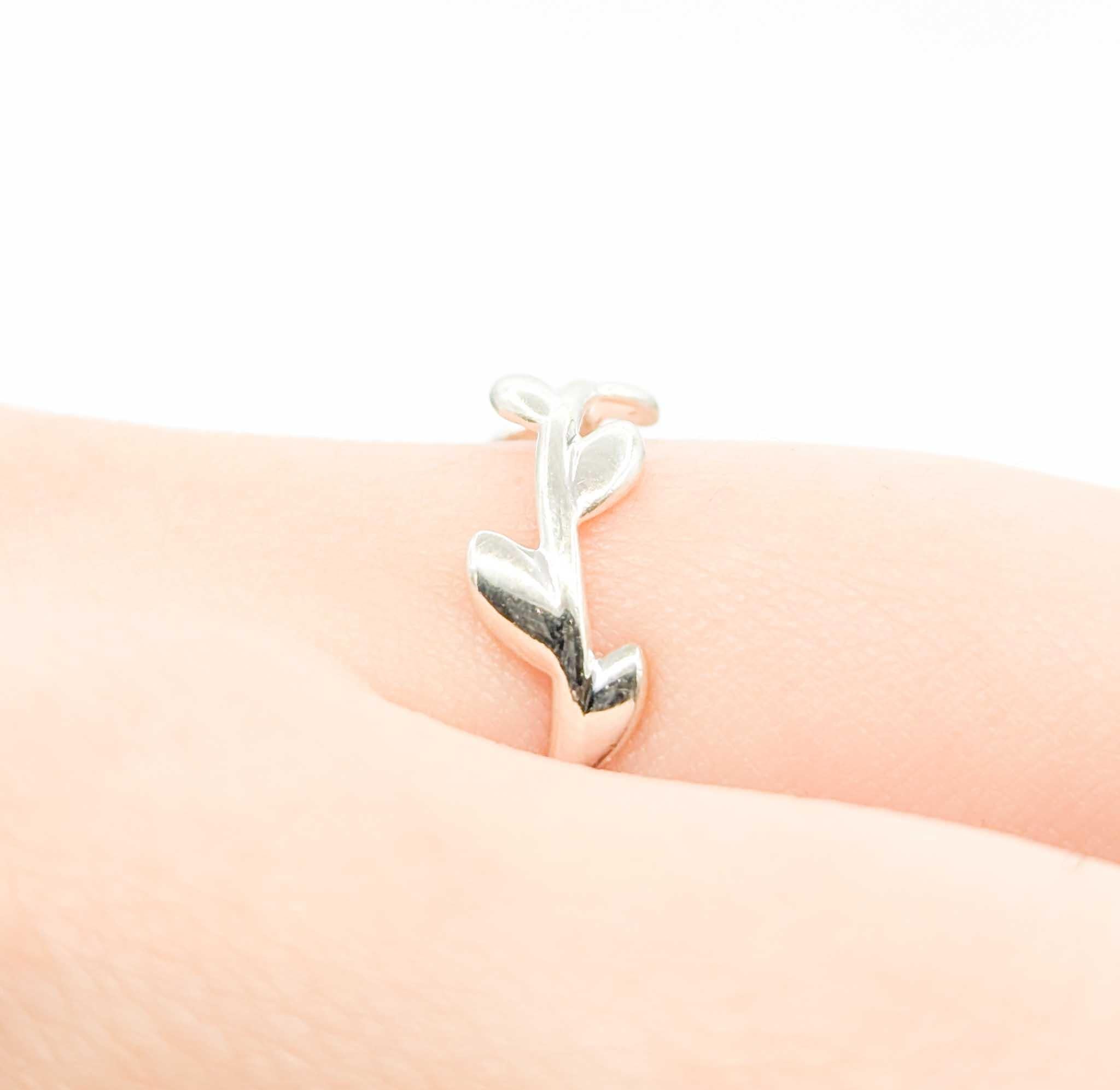 Introducing this exquisite designer fashion ring crafted in sterling silver, showcasing the timeless elegance of the Tiffany Vine design. The intricate vine motif weaves gracefully around the band, creating a harmonious blend of classic and