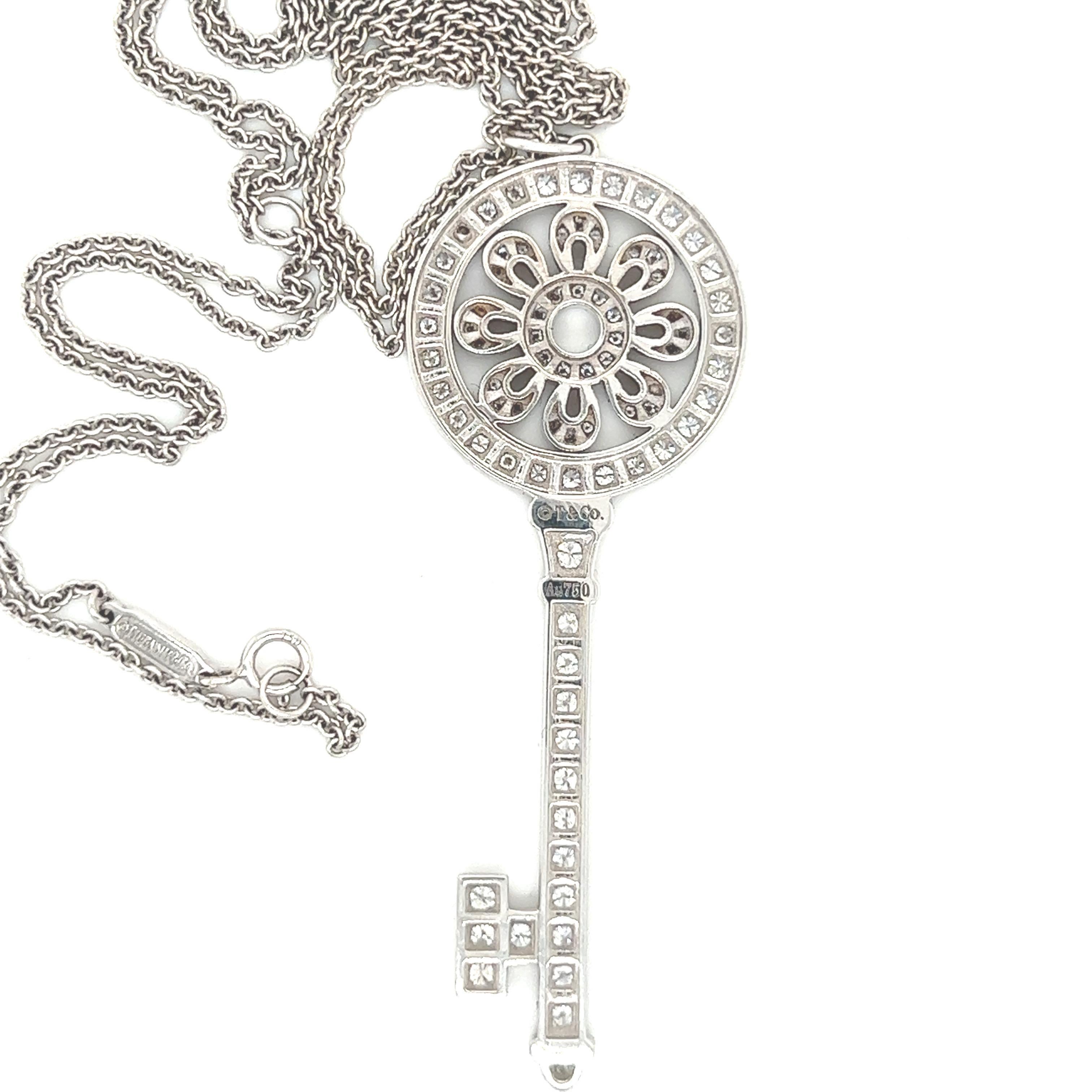 Brilliant Cut Tiffany white gold diamond large petal key pendant and chain.  For Sale