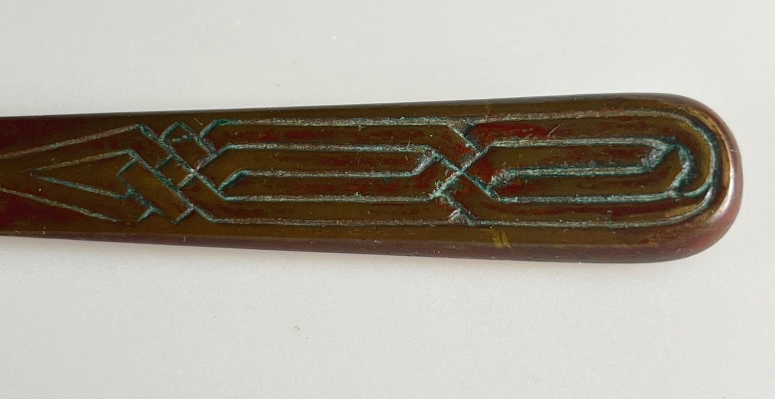 A gorgeous Tiffany Studios Zodiac pattern letter opener.  These retains significant amounts of red colored patina and some green.  And, although gorgeous, please note there is a ripple to the edge.  Someone must have tried to open something other