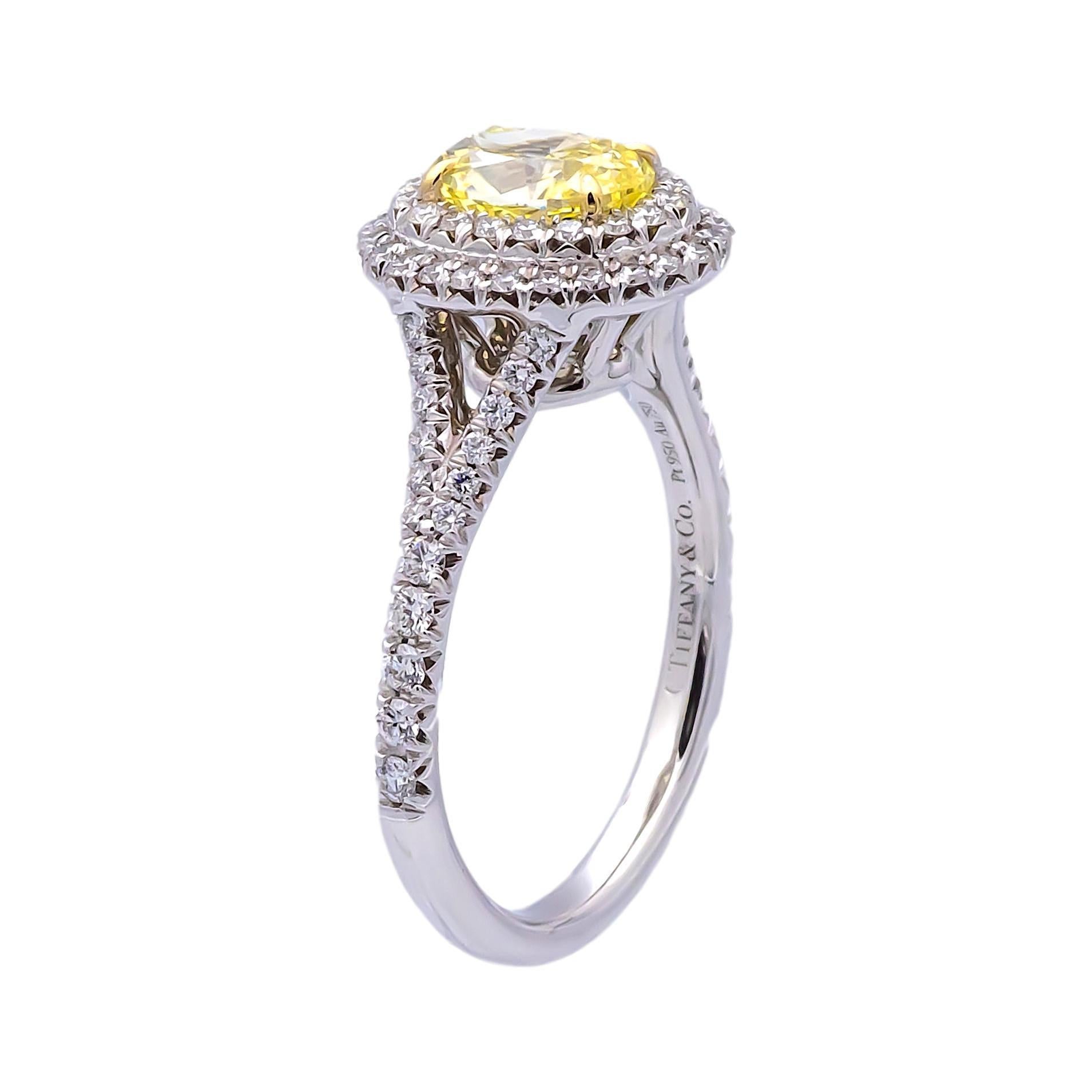 Tiffany & Co. Fancy Yellow engagement ring from the Soleste collection featuring a 1.04 carat oval center ,Fancy Intense Yellow VVS2 clarity finely crafted in platinum, accented by a double row halo and split shank design with round brilliant cut