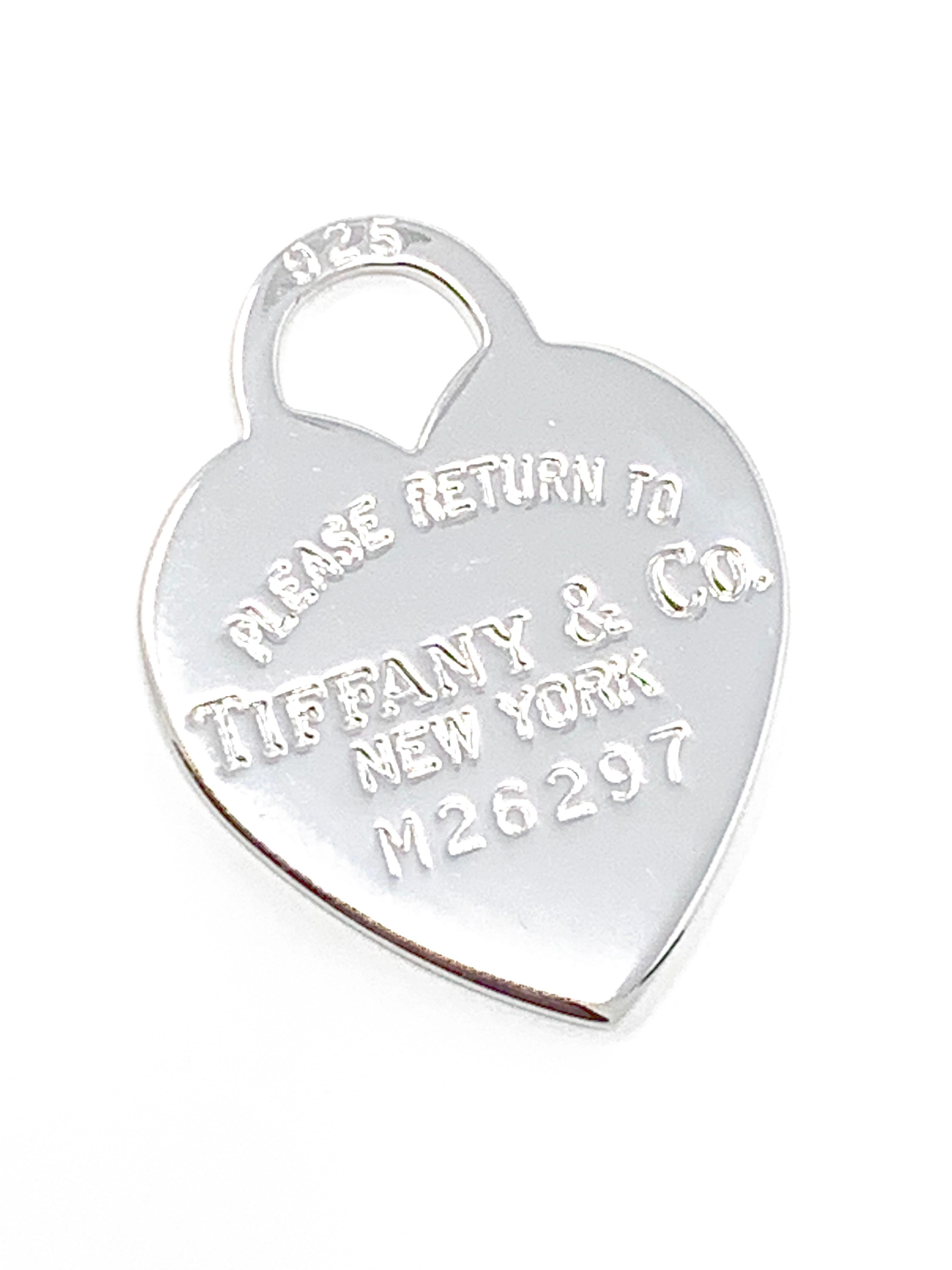 (Item Description) 
Brand - Tiffany&Co.
Gender - Unisex
Condition - Pre-Owned 
Style - Heart Pendant 
Metals - 925 Silver 
Coating - 24k White Gold
Weight - 4.0 Grams
Hall marks - Please Return to /Tiffany&co NY
length -1 Inch Aprox
Tiffany Jewelry