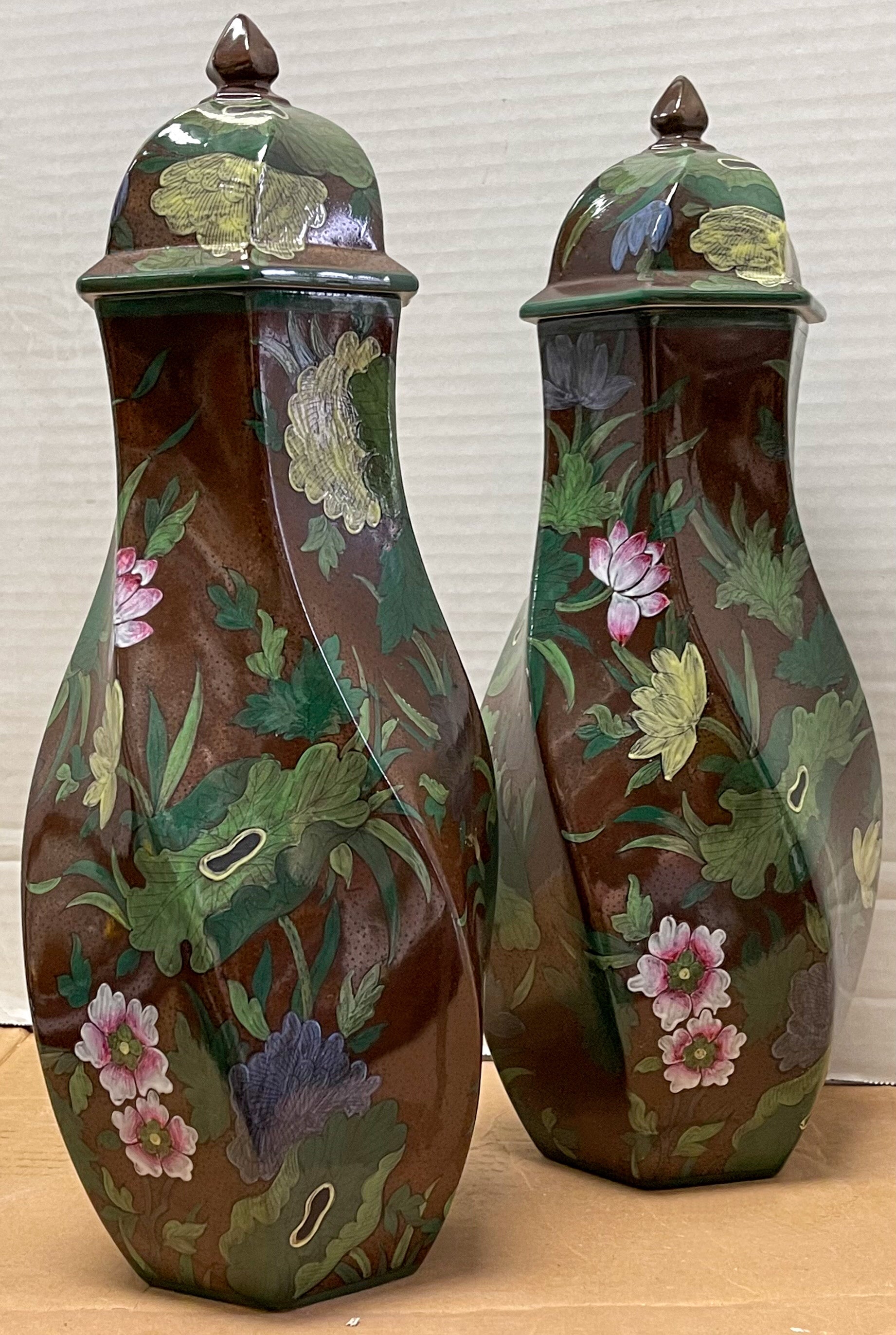 This is a lovely pair of French porcelain ginger jars hand crafted for Tiffany’s. The garnitures have a mottled brown background with winding green lotus leaves and pink blossums throughout both body and lid. They are marked.