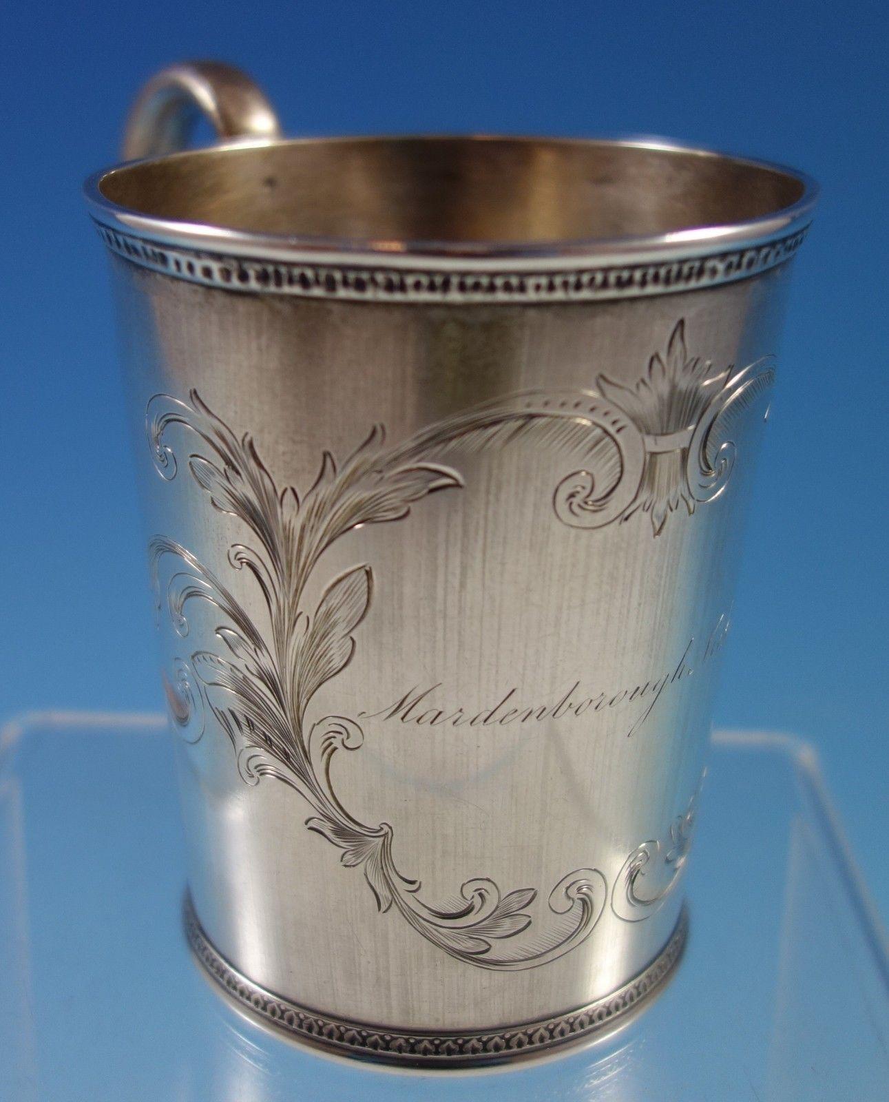 Coin silver baby cup made by Tifft and Whiting. The cup has beautiful engraved scrollwork and has a vintage inscription (see photos). The cup measures 4 x 4 1/4 . It is in good vintage condition. Lovely! 
