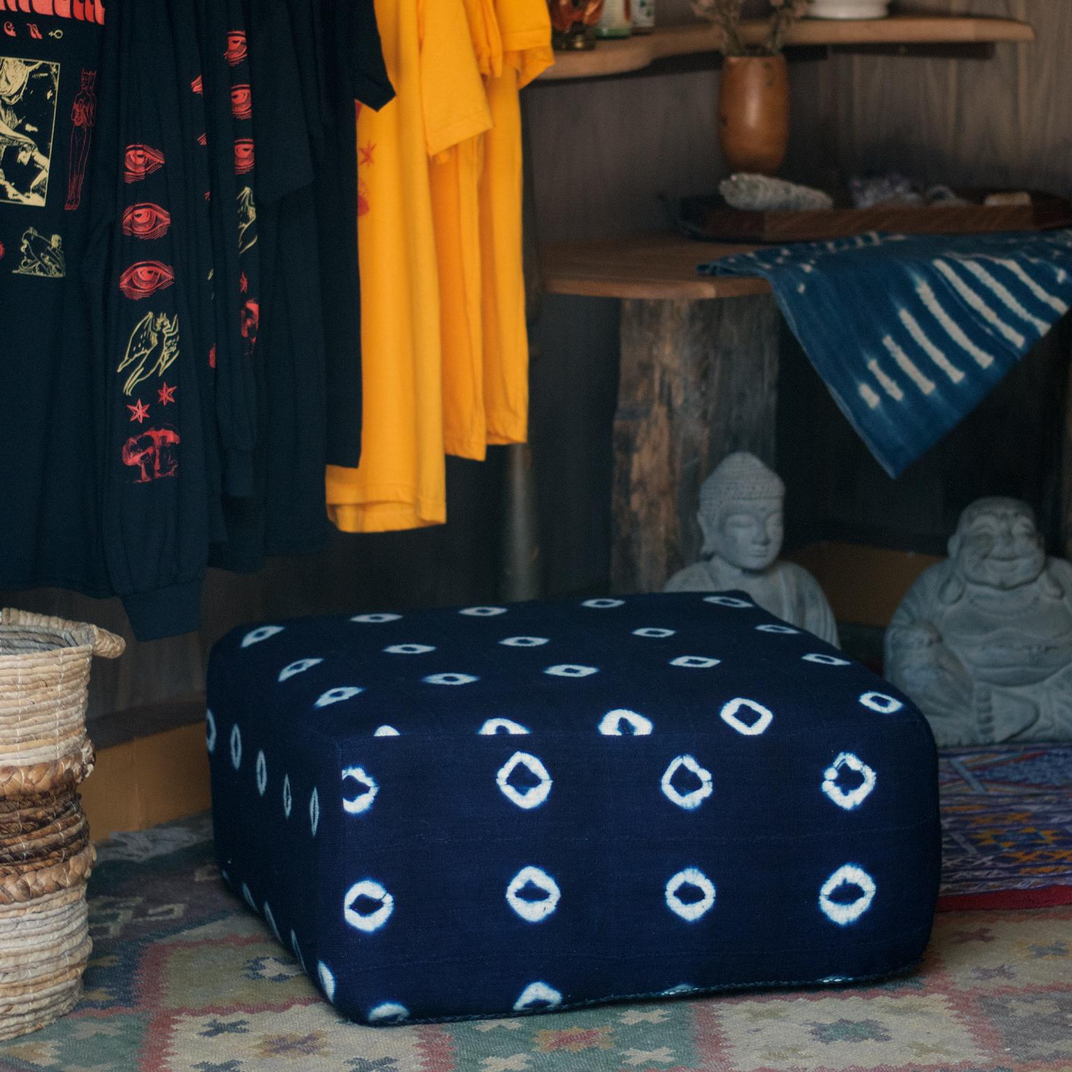 The Tifla floor cushion is made from vintage indigo African fabrics. 
Handcrafted fabric top and sides with a hand stitched leather bottom for durability and floor protection. 

Each pillow is unique
sizing and fabric choice is customizable.