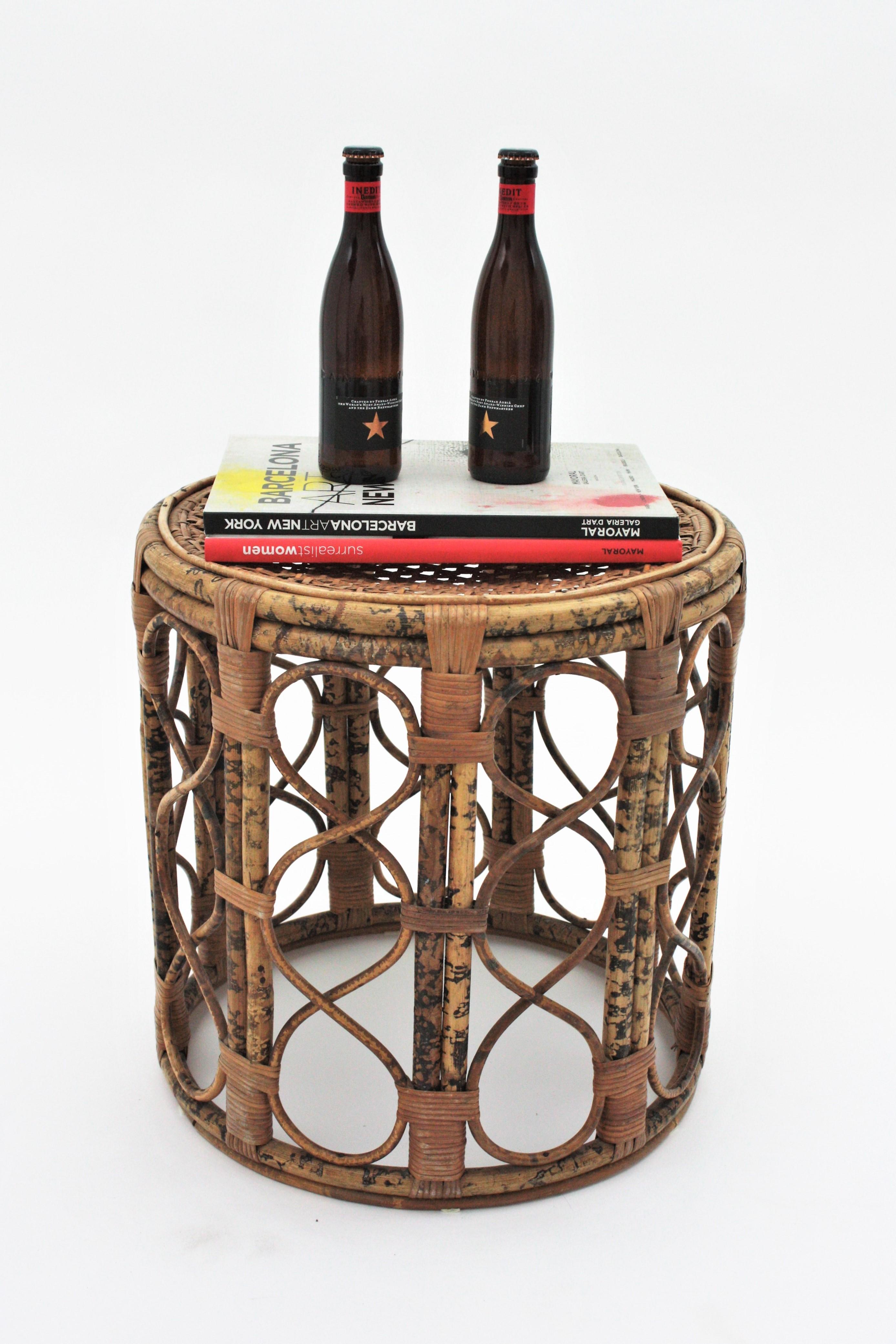 Eye-catching handcrafted tiger bamboo cylinder shaped side table with woven wicker rattan top. France, 1940s
This round end table has all the taste of the Mediterranean Coast and a beautiful design with accents of Bohemian style and reminiscences