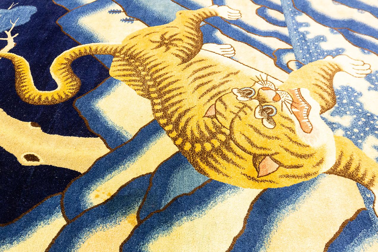 This intricately designed Peking carpet was created during a Golden Age of Chinese artistry, between 1900 and 1920. Its detailed craftsmanship is a true representation of the skill and artistry of the Chinese weavers. The soft colors and tiger
