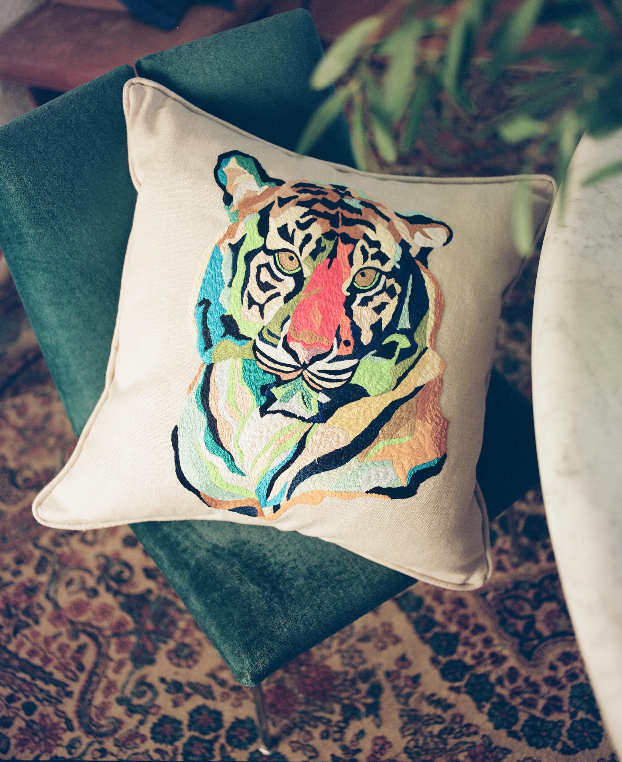 This decorative heavy cotton cushion is hand embroidered using silk and metallic vibrant threads. The portrait of a tiger and the unique use of neon accents have quickly become signature elements of this pillow series. The embroidery technique shows