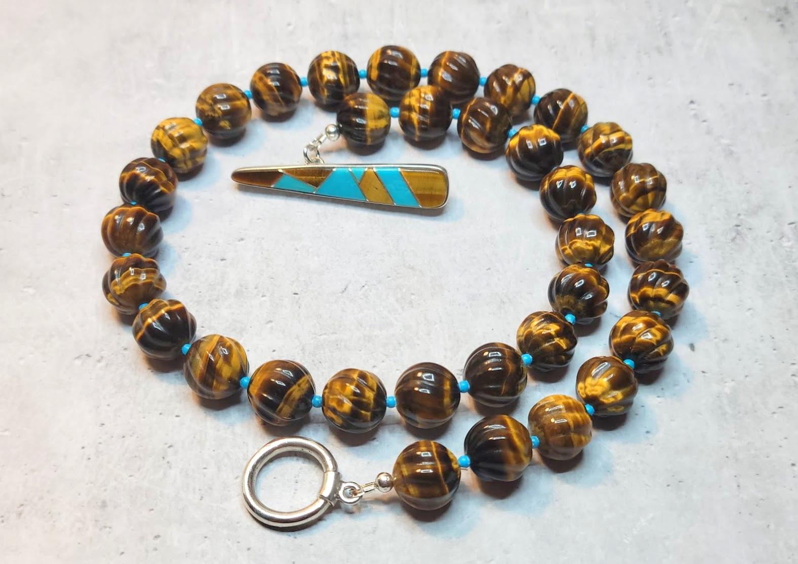 The length of the necklace is 19 inches (48 cm). The size of the 
carved round beads is 12 mm. These are lovely hand-carved tiger eye beads. The carving is a sophisticated swirl pattern. The carving is uniform and very nicely done.
The tones of the