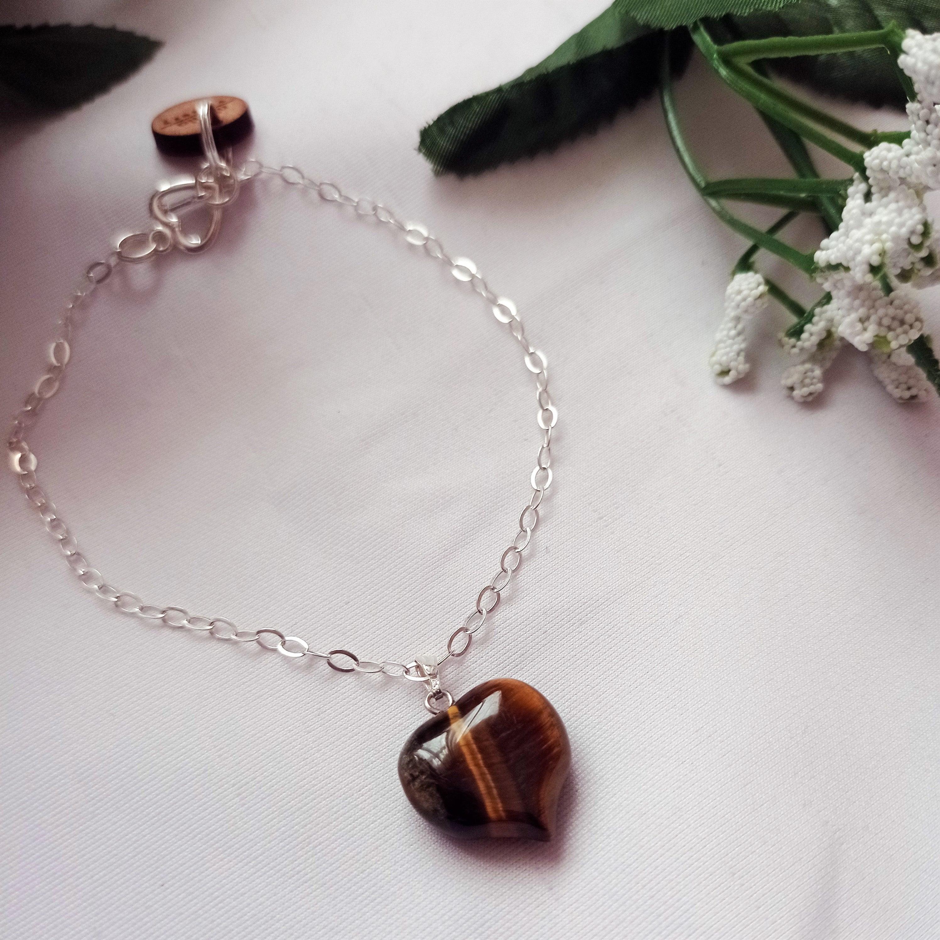 This beautiful Tiger Eye Bracelet with a Sterling Silver Heart Charm is the perfect addition to your jewelry collection. The warm, earthy tones of the Tiger Eye gemstone make this bracelet versatile and easy to wear with any outfit.

The heart charm