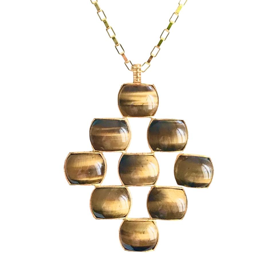 Made up of 9 specially cut Tiger-Eye cabochons & set in a 'chiselled' mount, our Brick pendant looks fabulous worn day or night. 

We adore using Tiger-Eye in our jewellery, and feel its' luxurious lustre lends itself particularly well to this piece