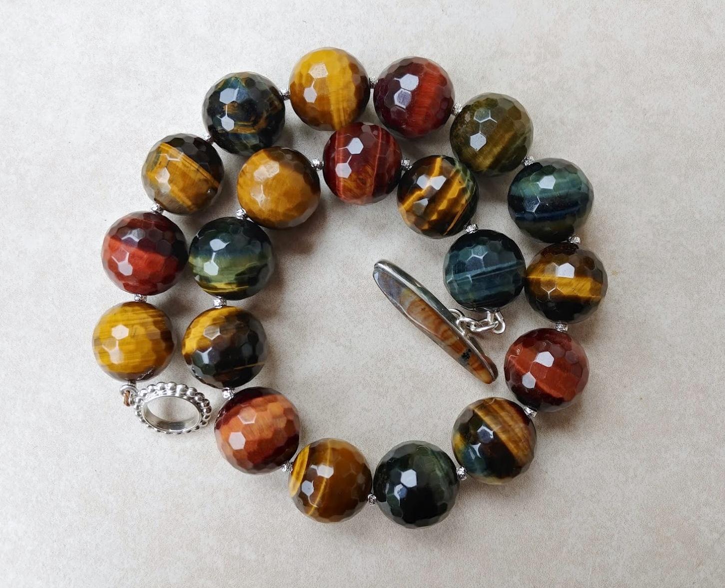 Faceted Multi-Color Tiger Eye Beaded Necklace

The length of the necklace is 18 inches (45.7 cm). The size of the faceted round beads is 20 mm.
The tones of the beads are a wondrous golden brown, caramel gold, silky red, and sparkly gold blue are so