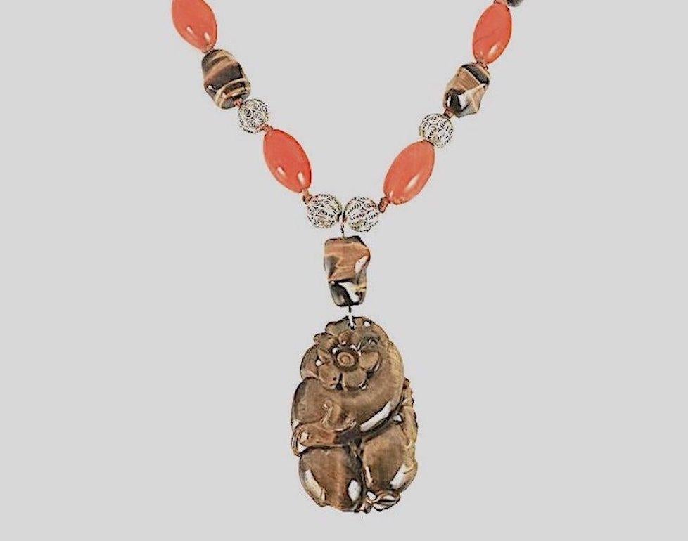 A Vintage Masterful Intricately Carved Large Lustrous Finest Tiger Eye Fish carved with a Flower, and Fauna Pendant Necklace. Artistically strung on precious beads of open work Sterling, Tiger Eye, and Carnelian with a very nice 925 Sterling