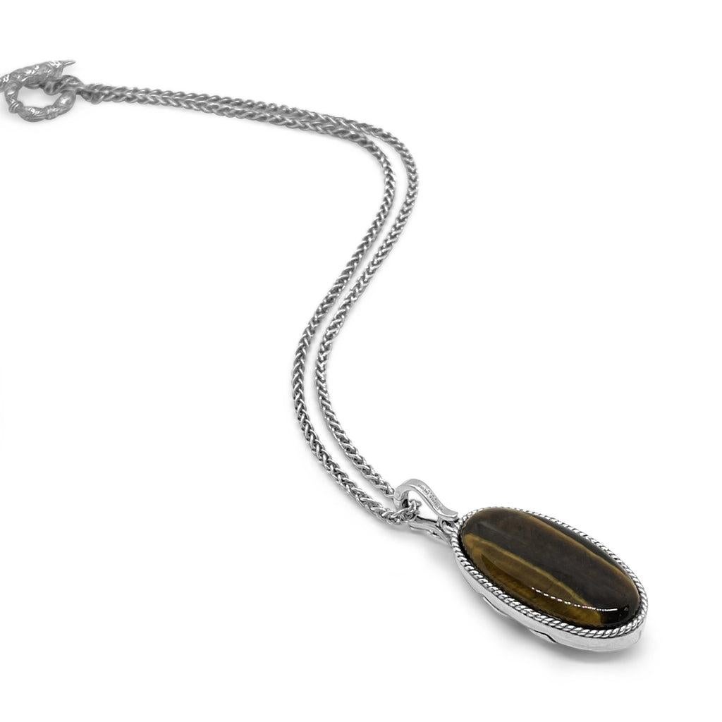 Immerse yourself in the captivating allure of the Tiger Eye Reversible Necklace, a sterling silver masterpiece crafted to exude timeless elegance and versatility. This exquisite piece features a reversible pendant, showcasing the rich, earthy hues