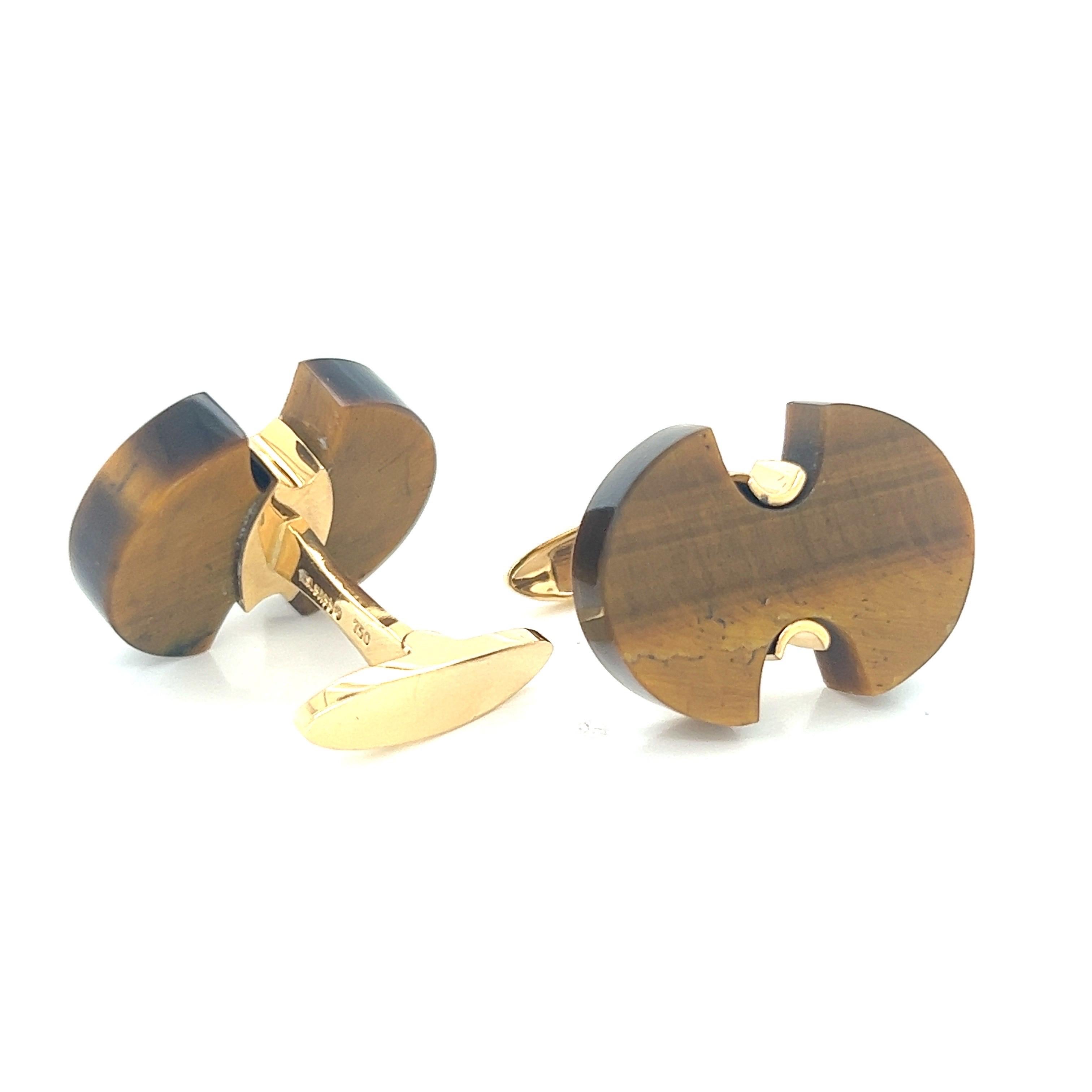 Designed by the renowned designer Lois D. Sasson, these 14k yellow gold cufflinks with a hand-cut tiger eye top showcase a harmonious blend of elegance and natural beauty.
The cufflinks feature a carefully hand-cut tiger eye gemstone, known for its