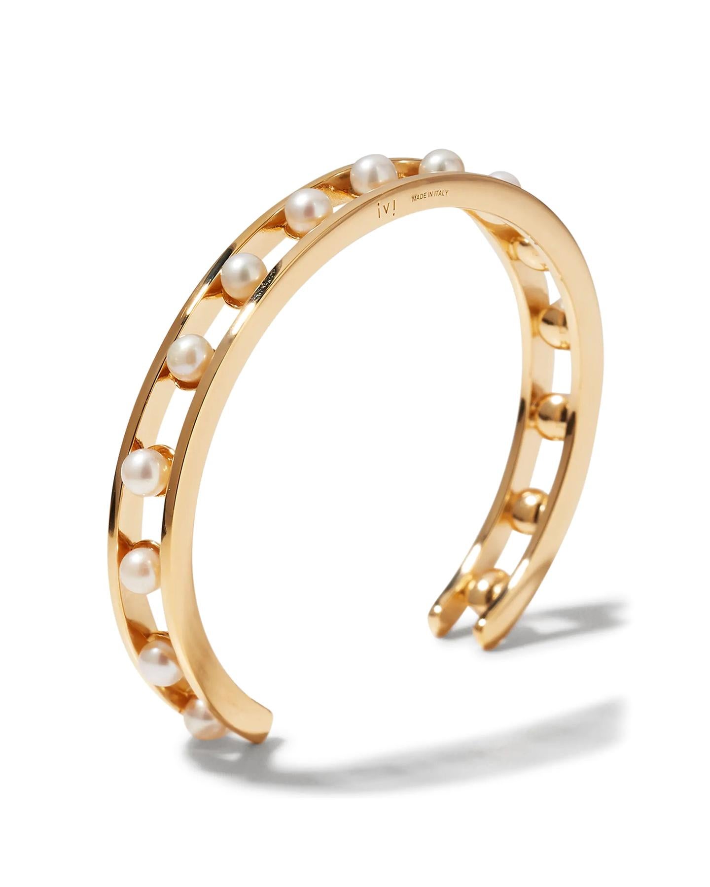 The gold-plated Tiger Pearl cuff features a cutout center, creating the illusion of floating pearls. This piece stacks perfectly with similar styles in the collection.

Details:
925 Sterling Silver
Plated in 18K Yellow Gold
Weight: 0.6 oz (17